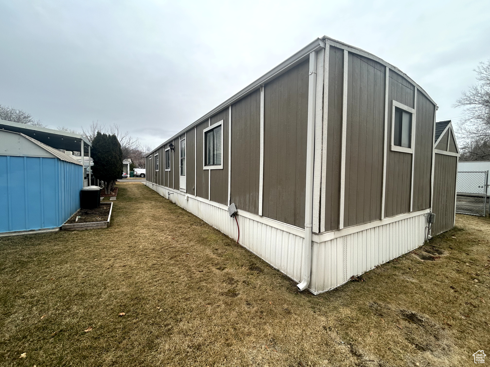 View of property exterior with a yard