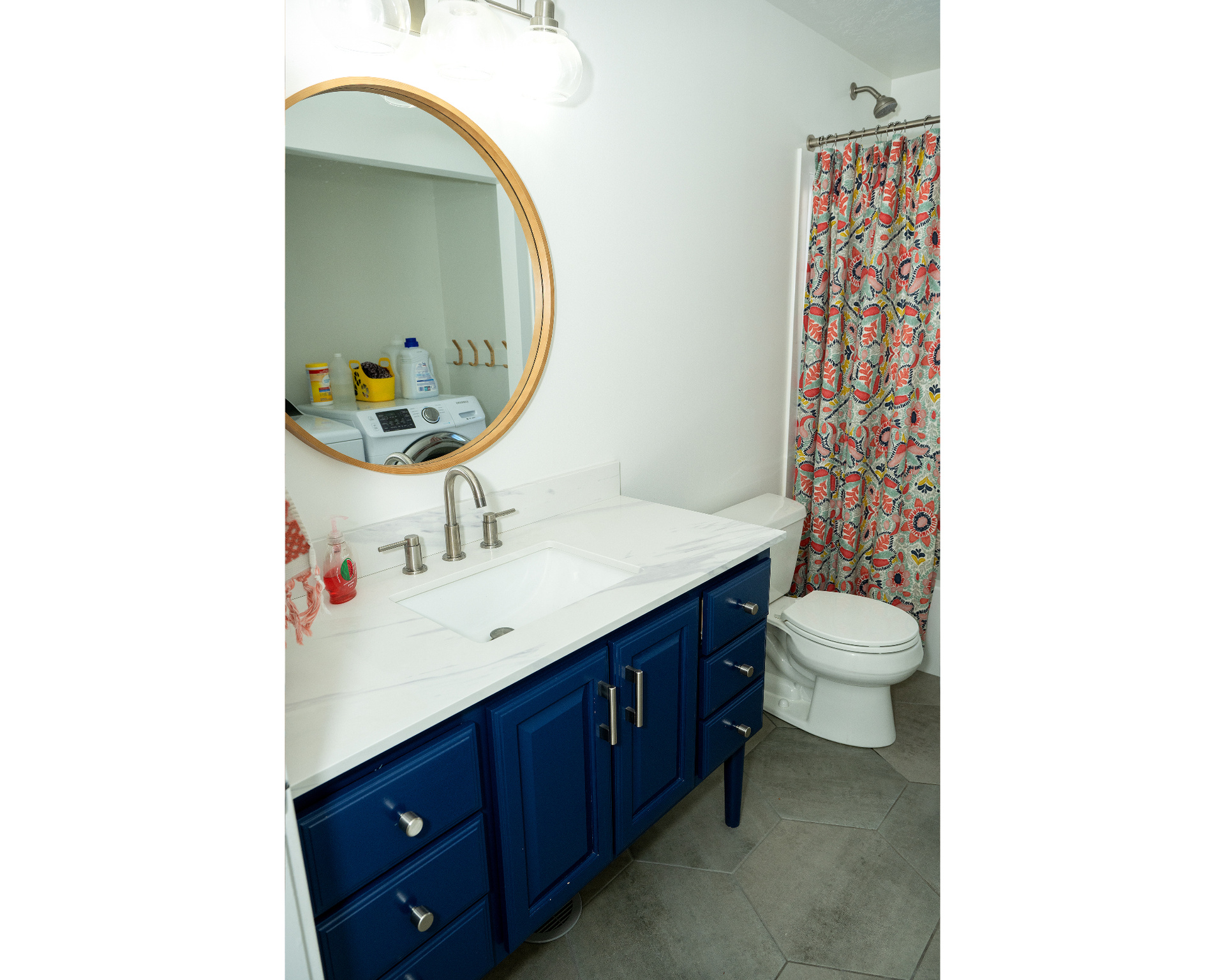 Bathroom with toilet, a shower with curtain, tile patterned flooring, and vanity