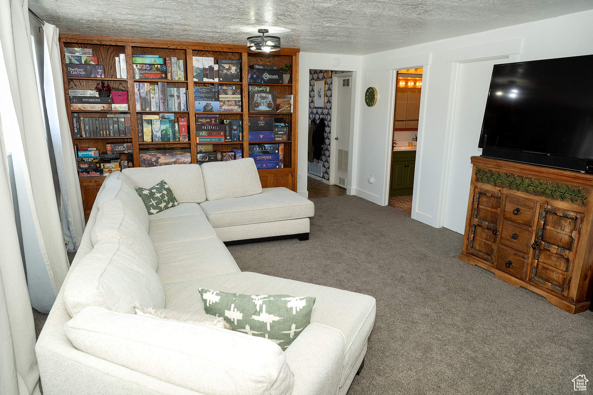 Living room featuring carpet and a textured ceiling