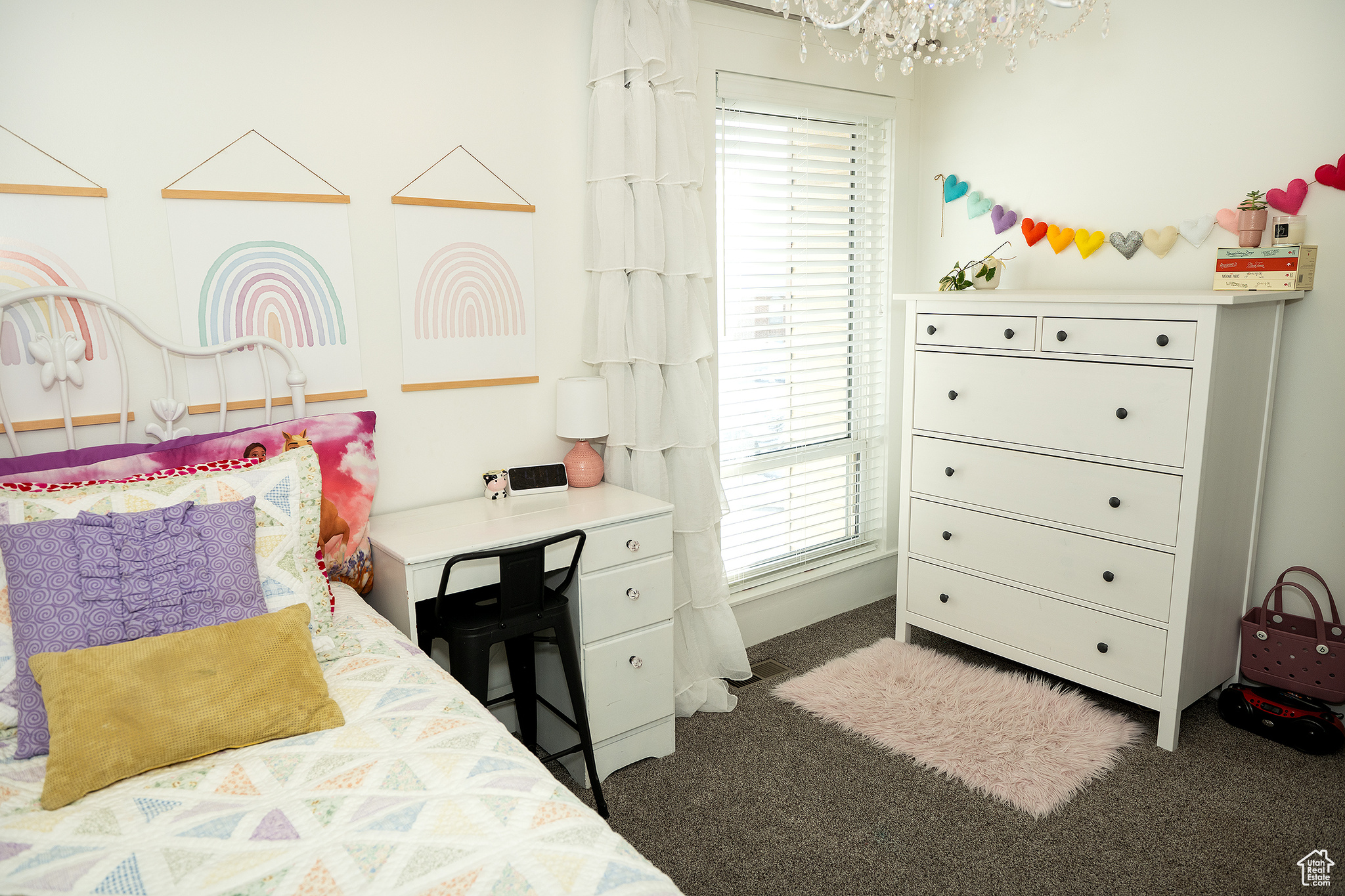 Carpeted bedroom featuring a chandelier