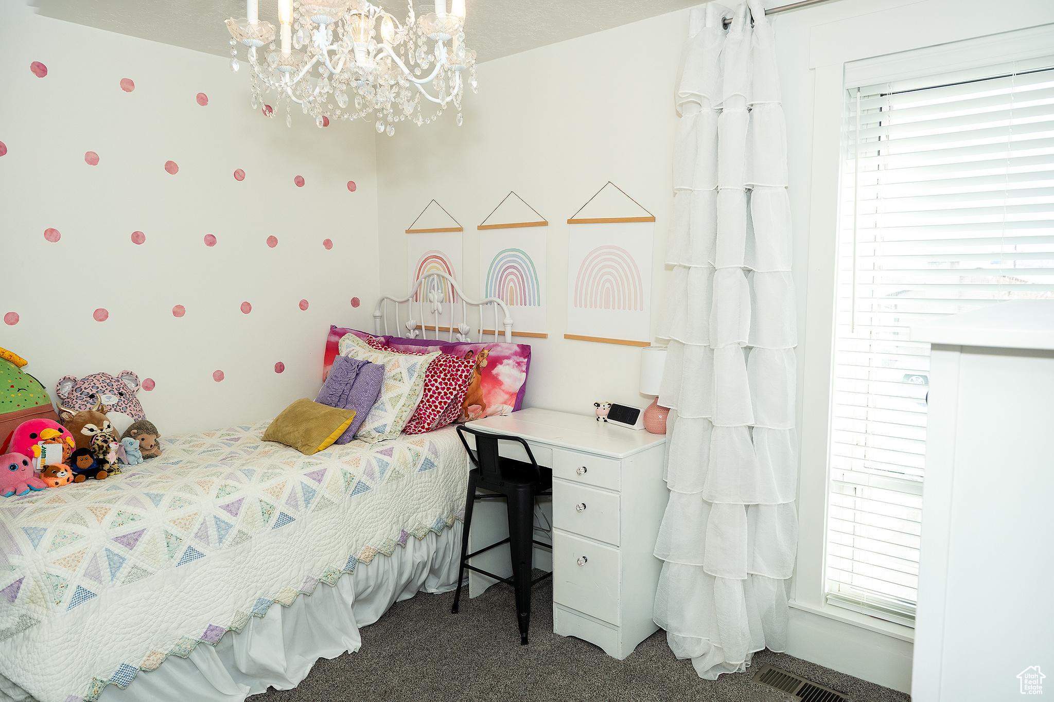 Carpeted bedroom with a notable chandelier