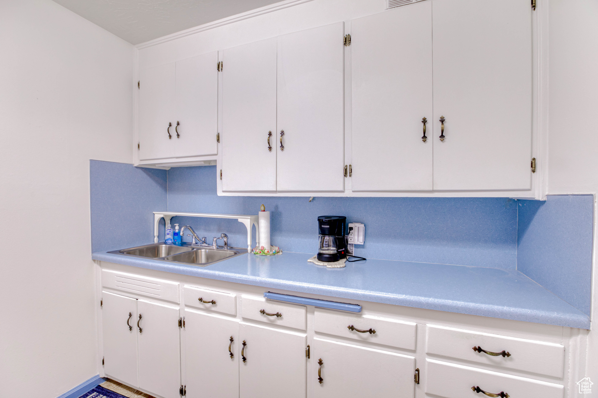 Kitchen with sink and white cabinets