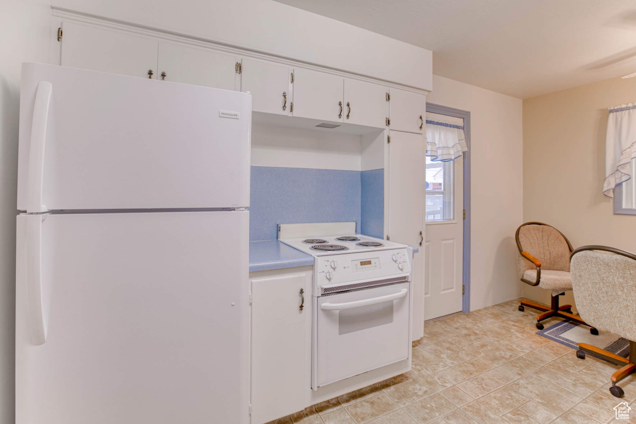 Kitchen with white appliances and white cabinets
