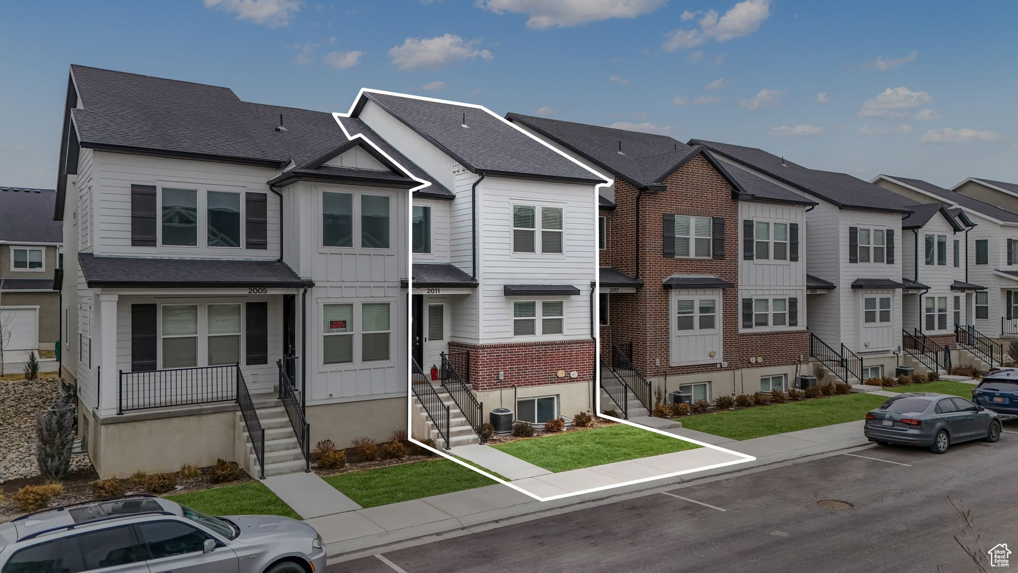 View of property with a front lawn and central air condition unit