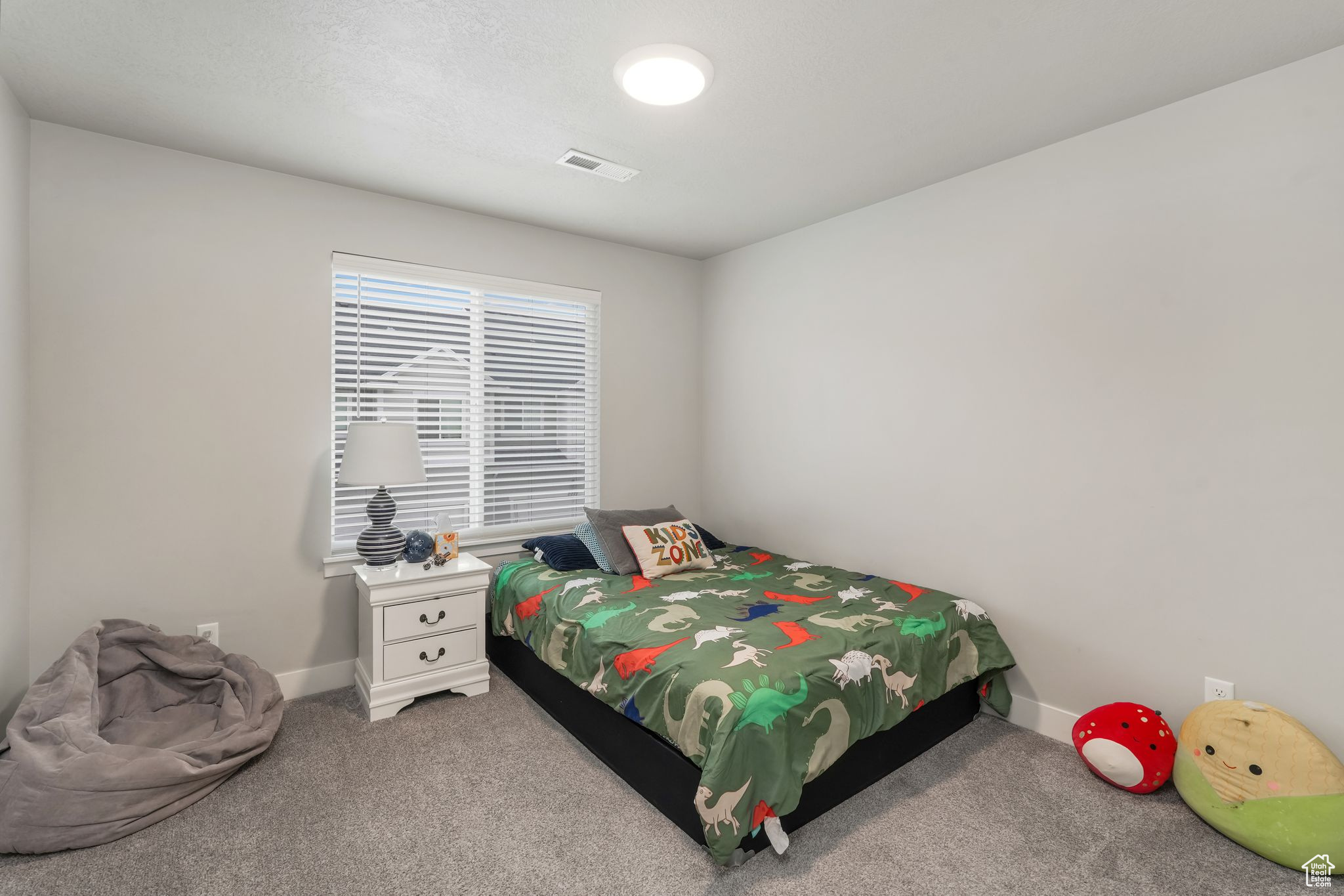 Bedroom featuring light colored carpet