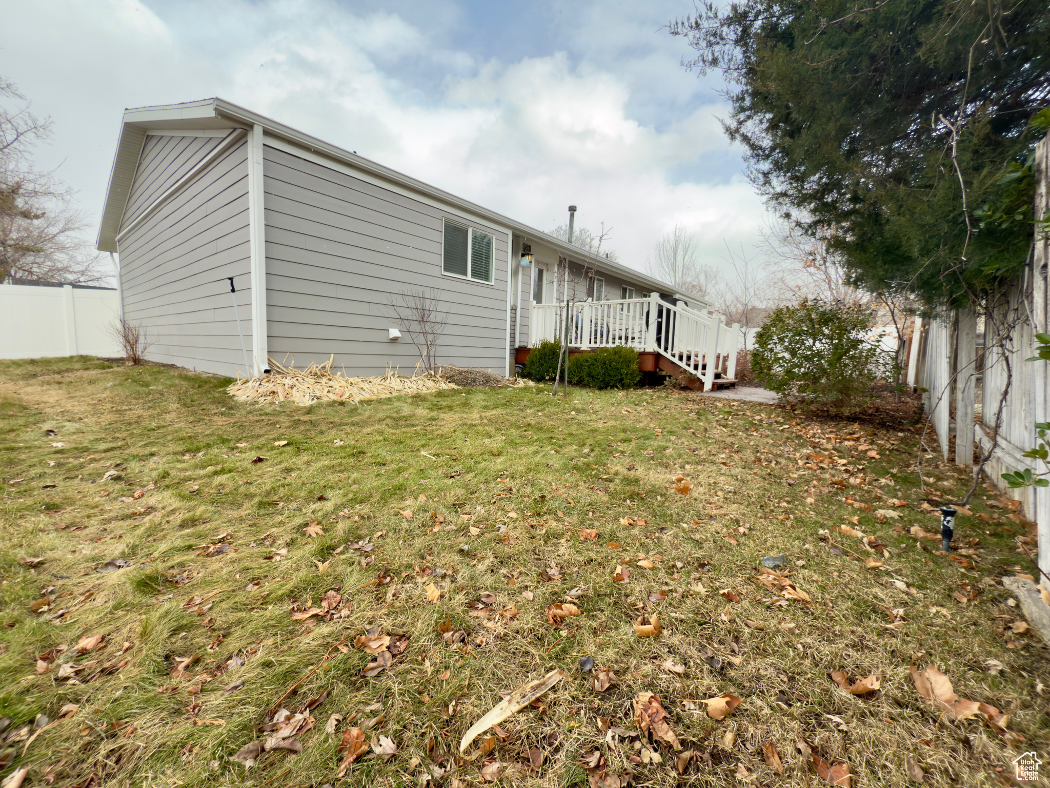 Rear view of property featuring a yard and a deck