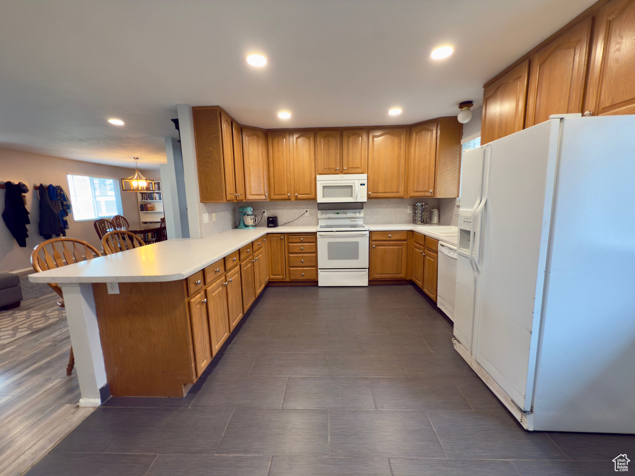 Open kitchen with lots of cupboards & tile floors