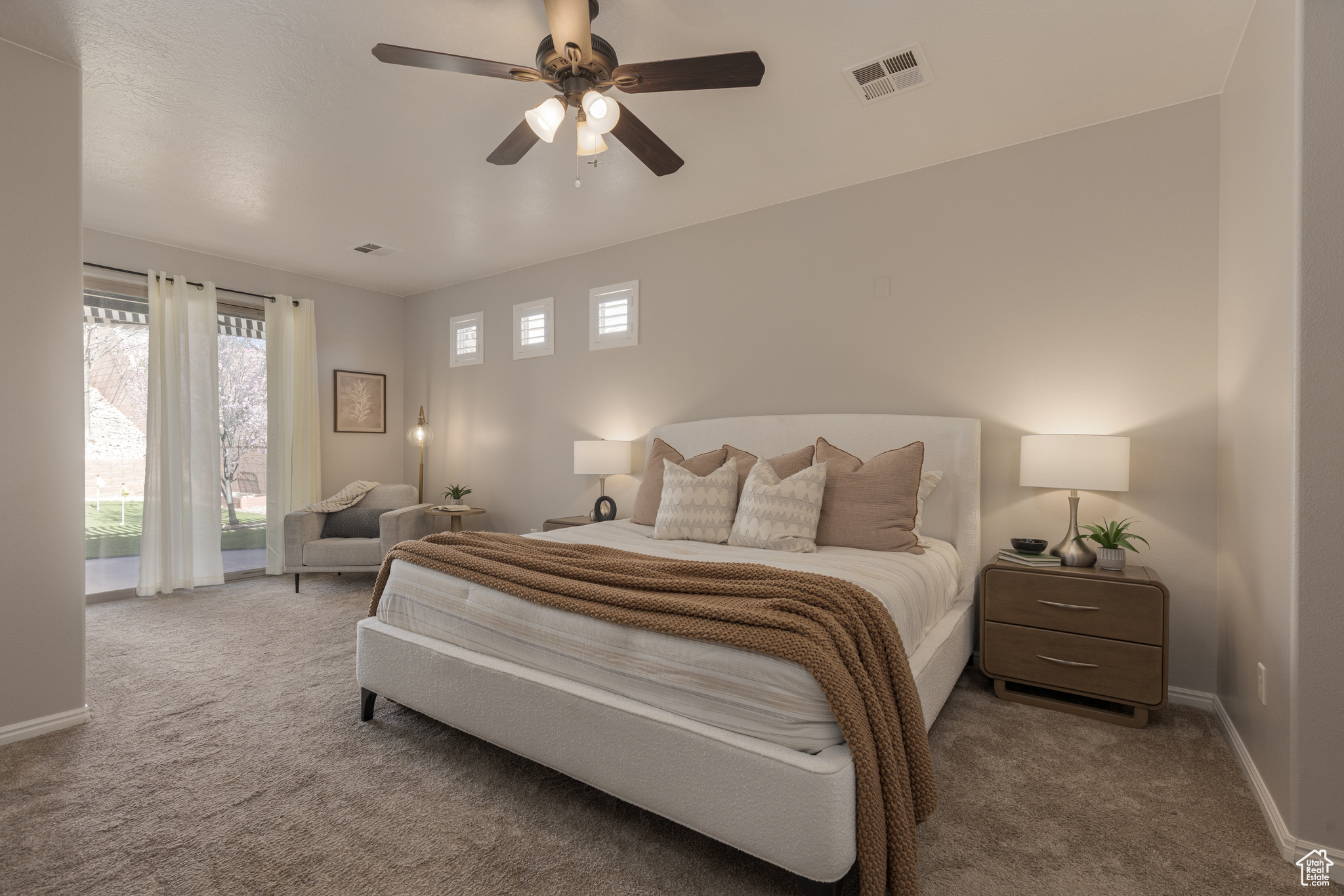 Primary bedroom with a ceiling fan, access to outside, and carpet floors