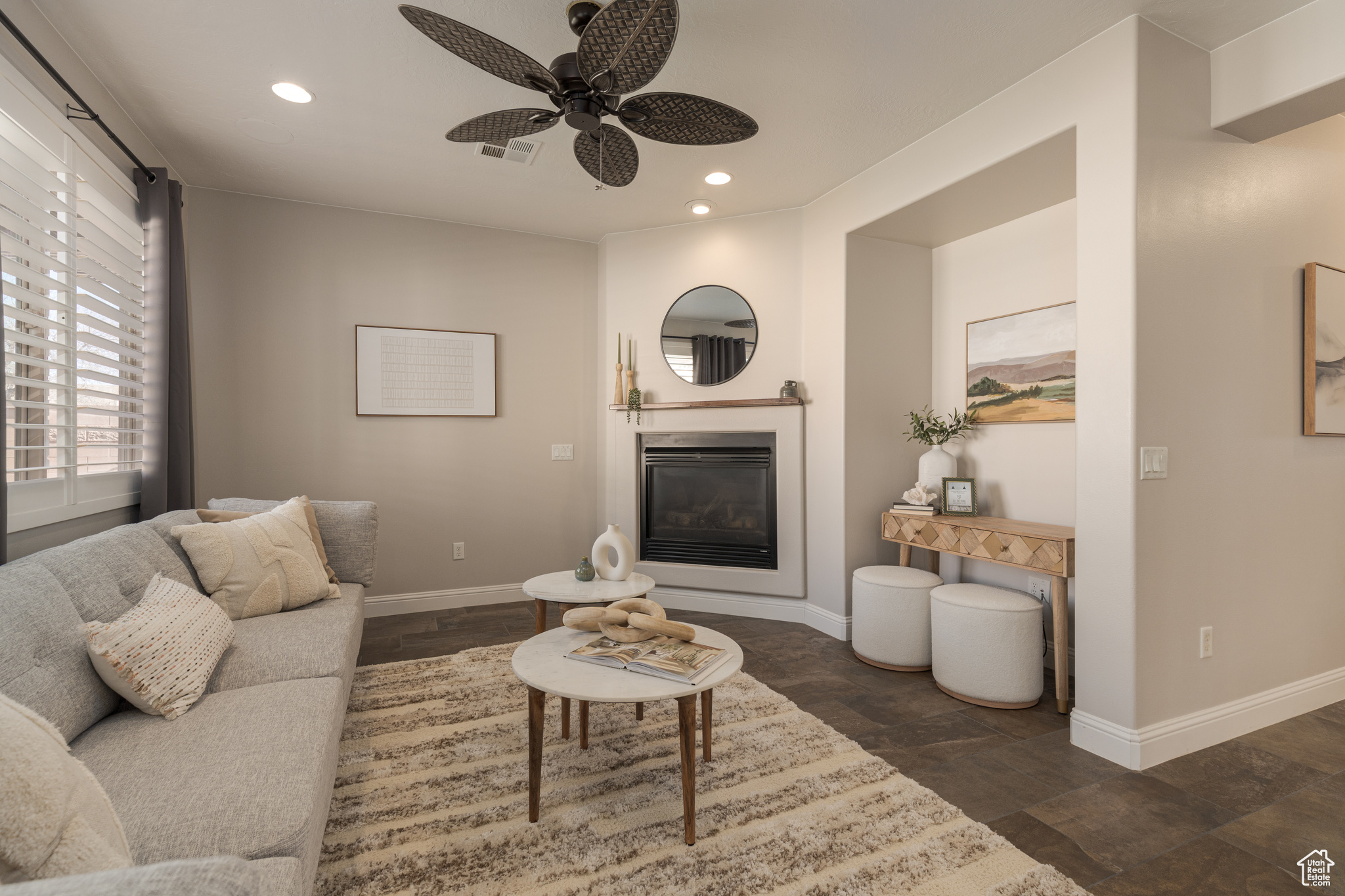 Living room featuring recessed lighting, and a glass covered fireplace
