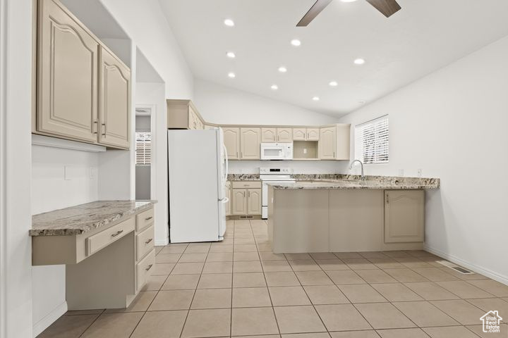 Kitchen with white appliances, light tile patterned floors, lofted ceiling, ceiling fan, and light stone countertops
