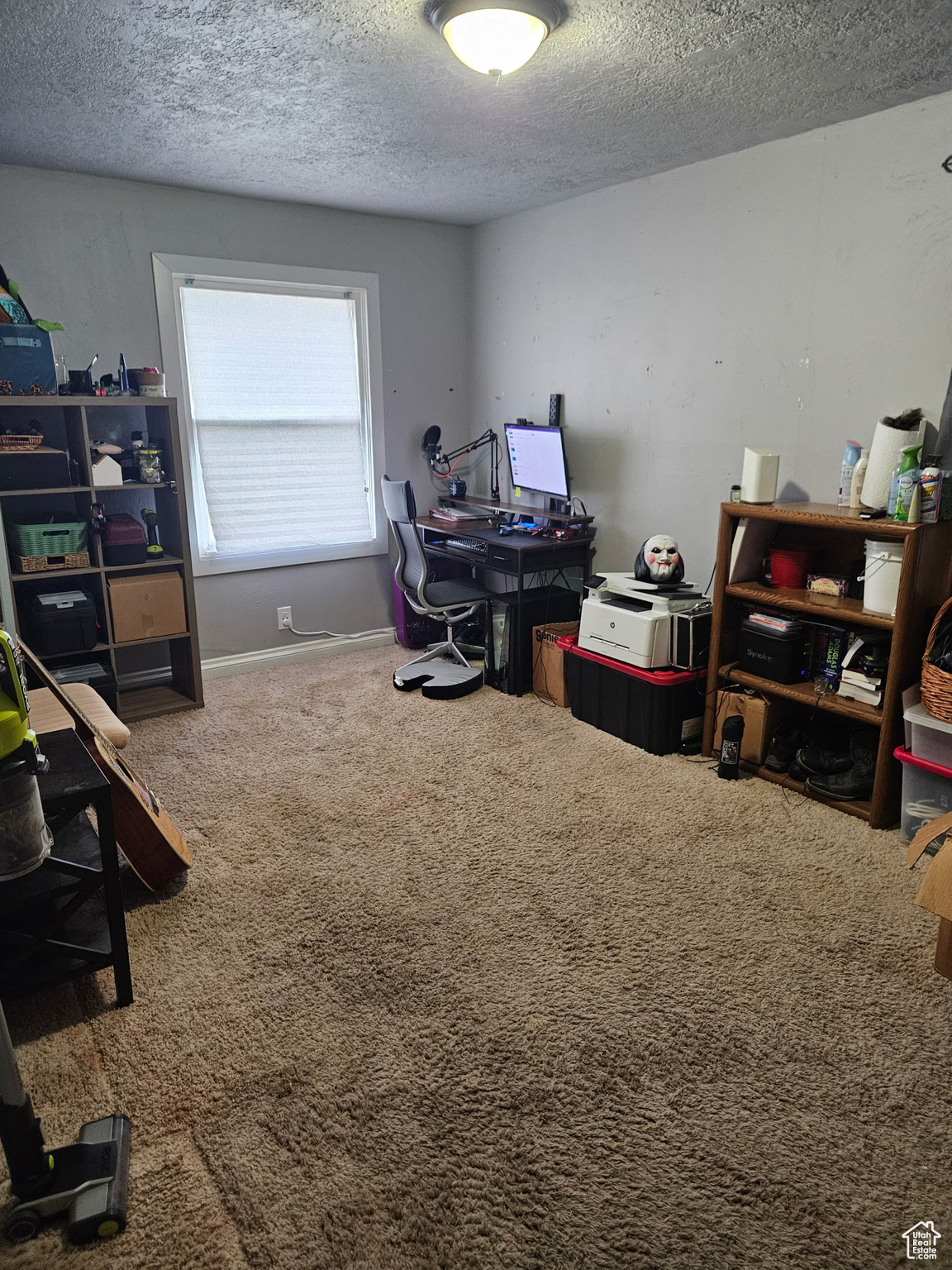 Office space featuring baseboards, a textured ceiling, and carpet flooring