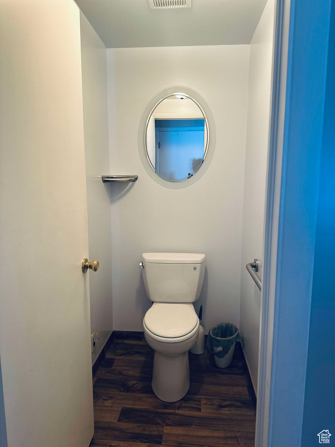 Bathroom with hardwood / wood-style flooring and toilet