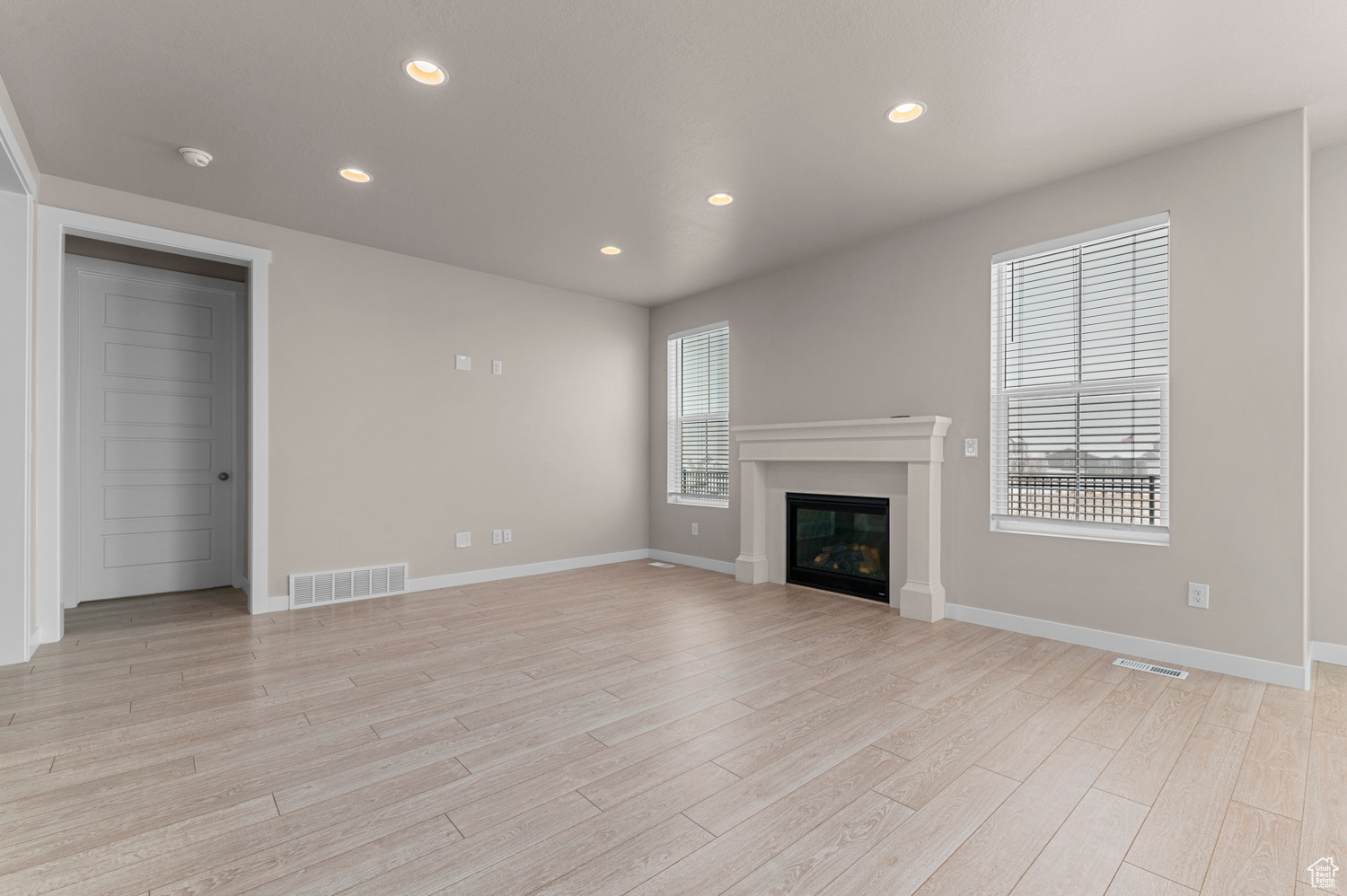 Unfurnished living room with light wood-type flooring