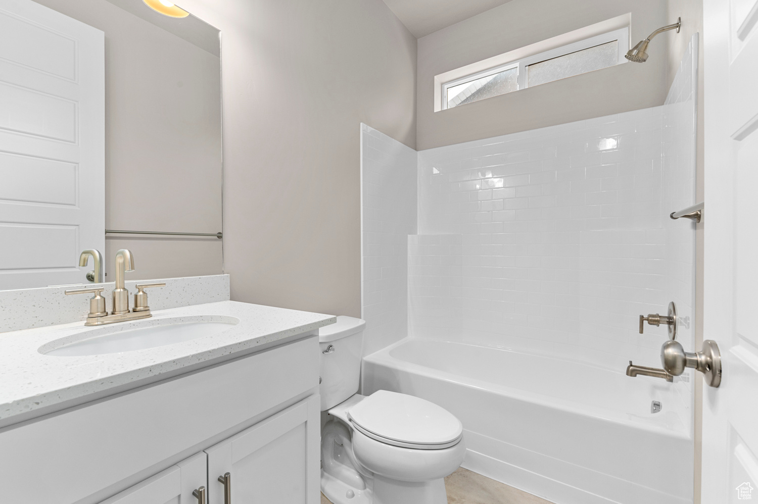 Full bathroom featuring vanity, toilet, and  shower combination