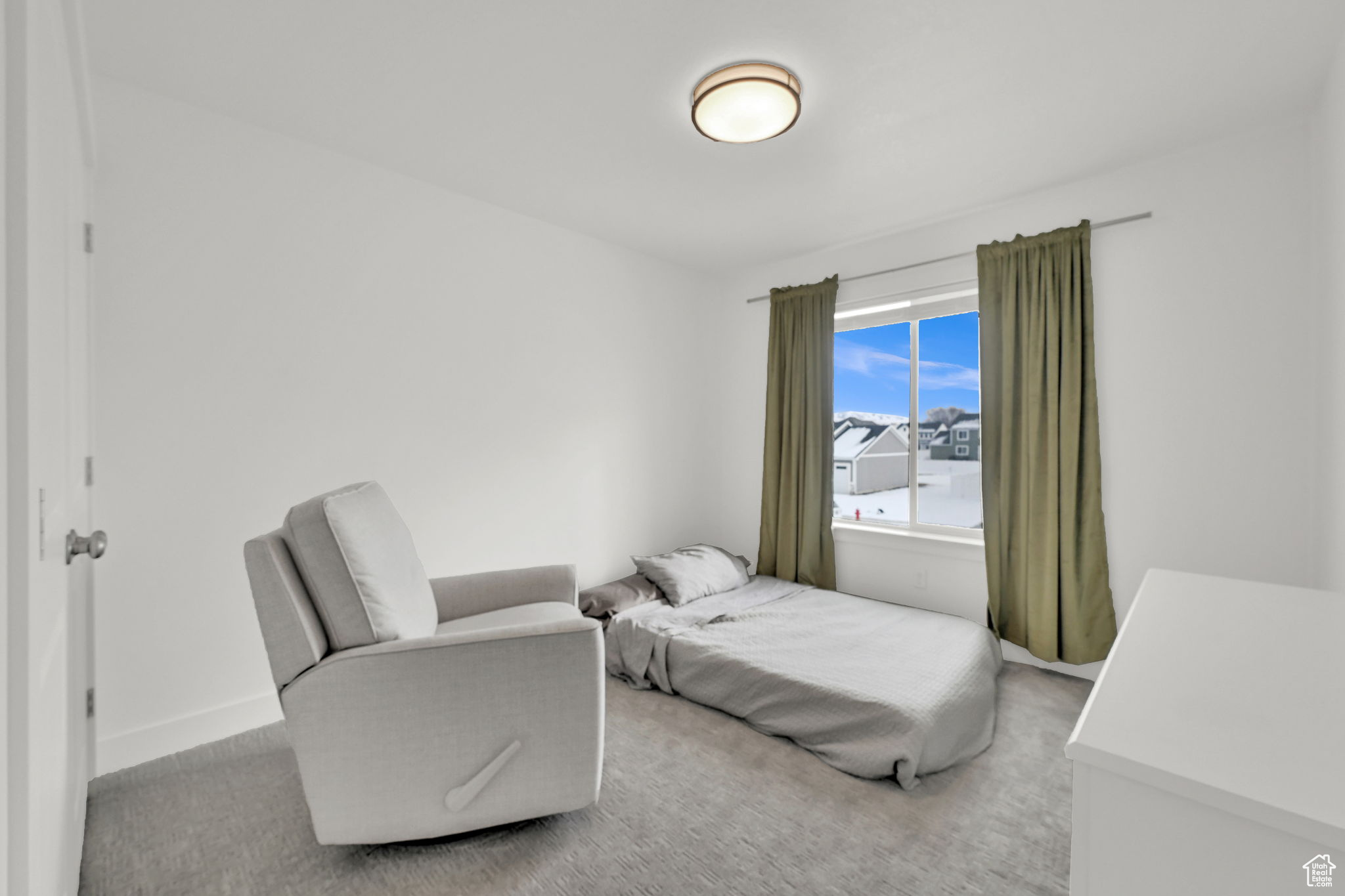 Bedroom with light colored carpet