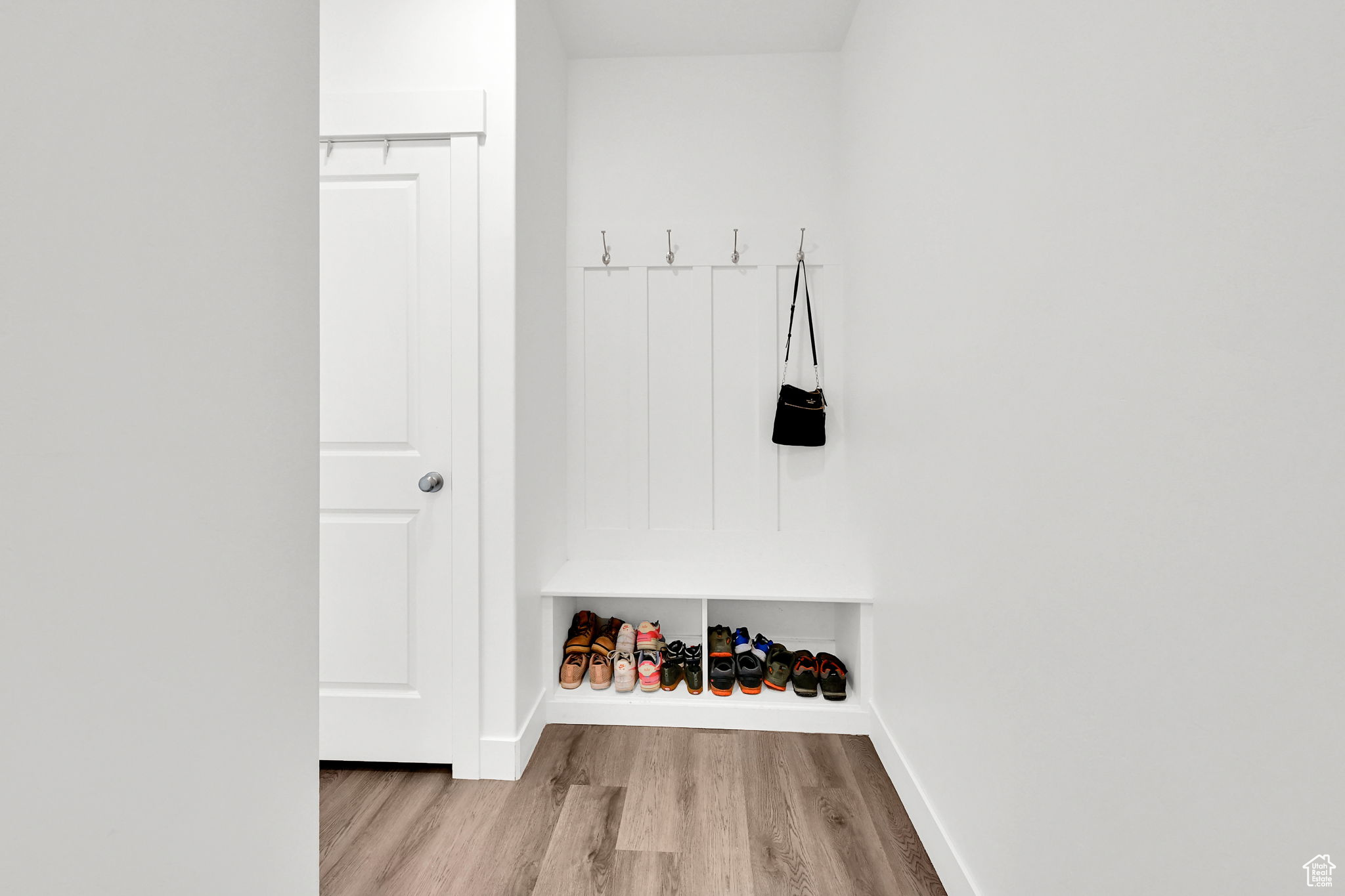 Mudroom with light hardwood / wood-style flooring