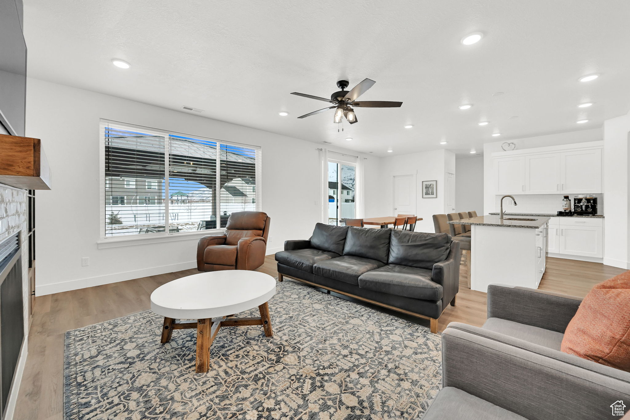 Living room featuring ceiling fan, hardwood / wood-style flooring, and sink