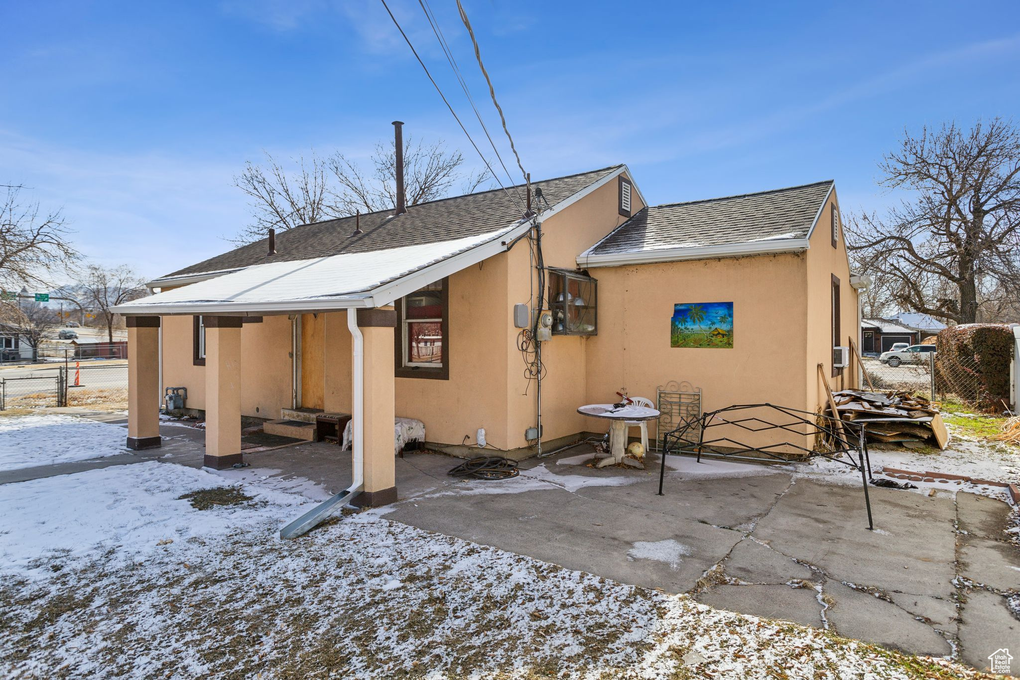Snow covered property with a patio area