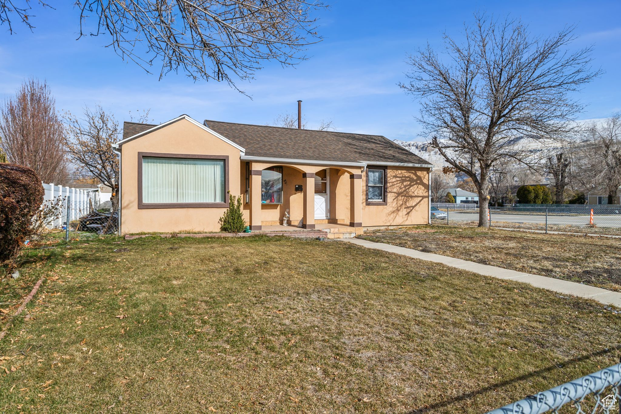 Single story home with a front lawn
