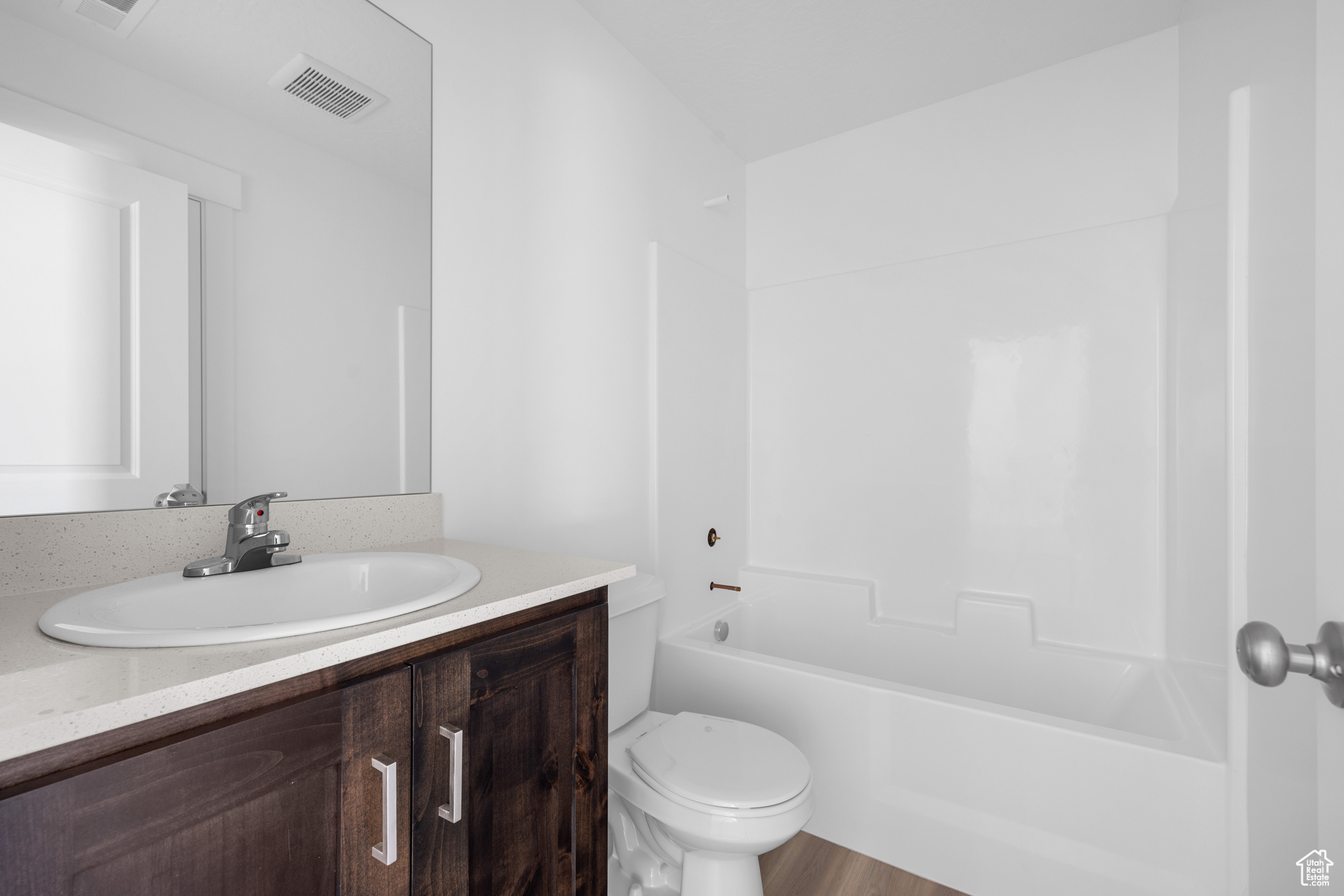 Full bathroom featuring vanity, toilet, and  shower combination