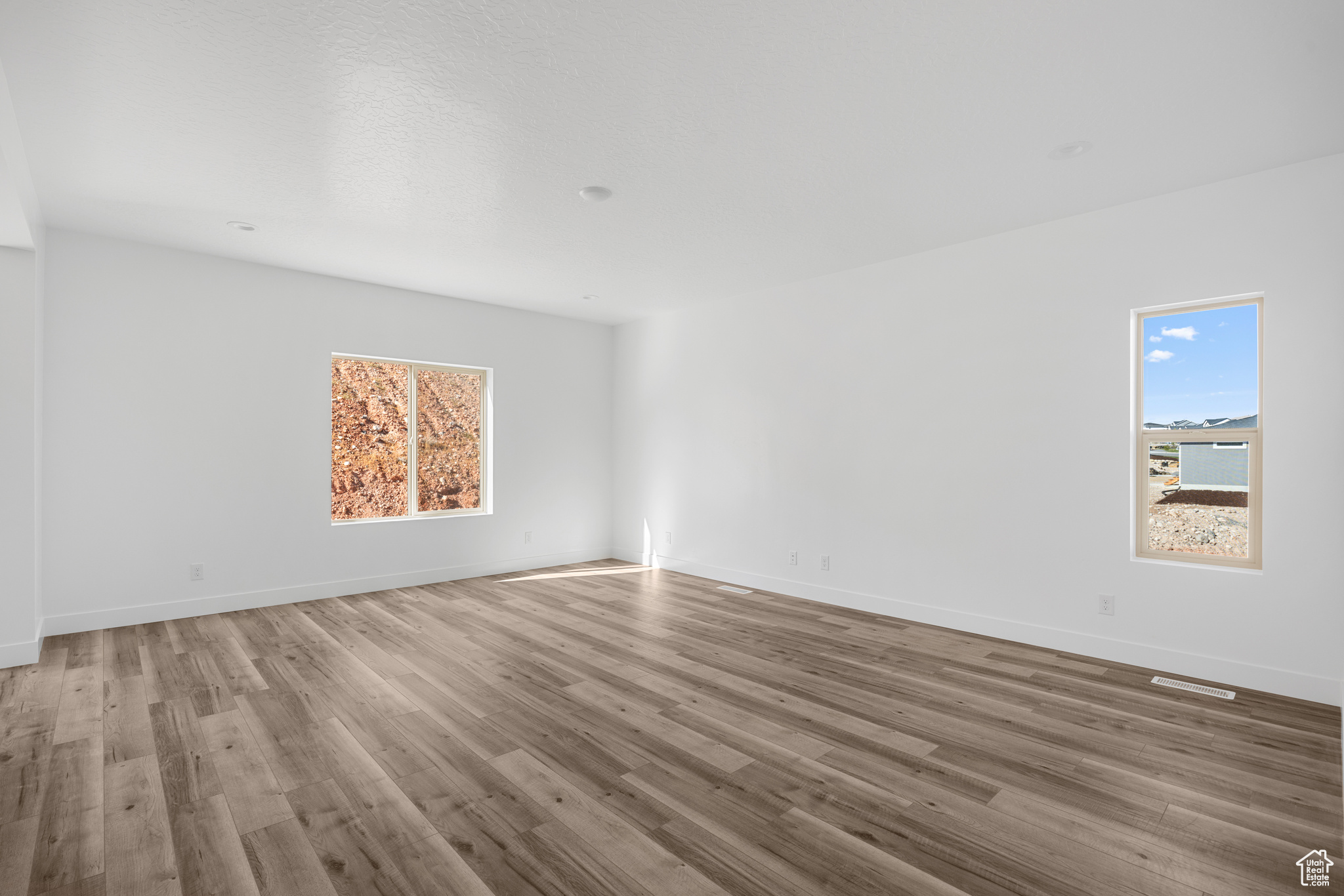 Spare room featuring wood-type flooring