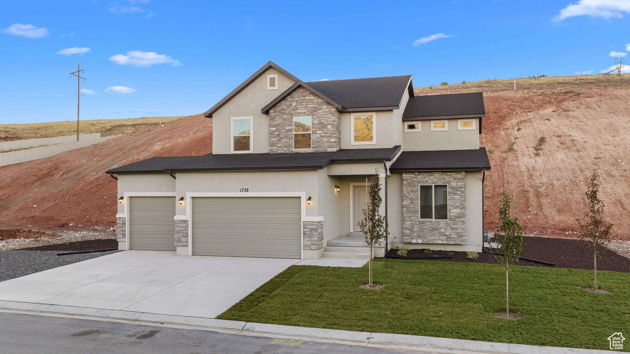 View of front of property with a front yard and a garage