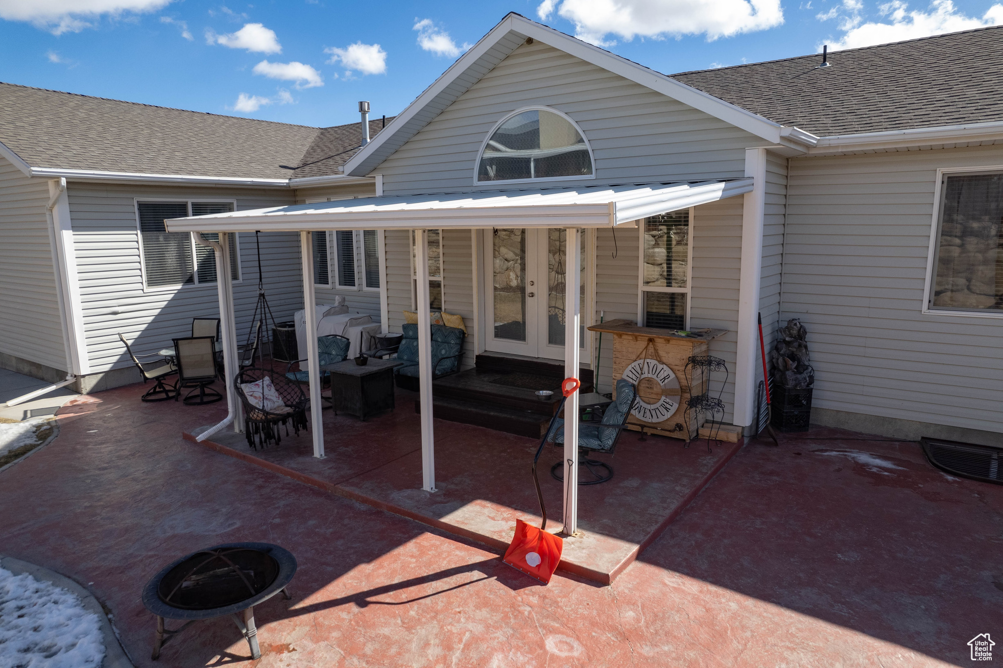 Rear view of property featuring a patio and french doors