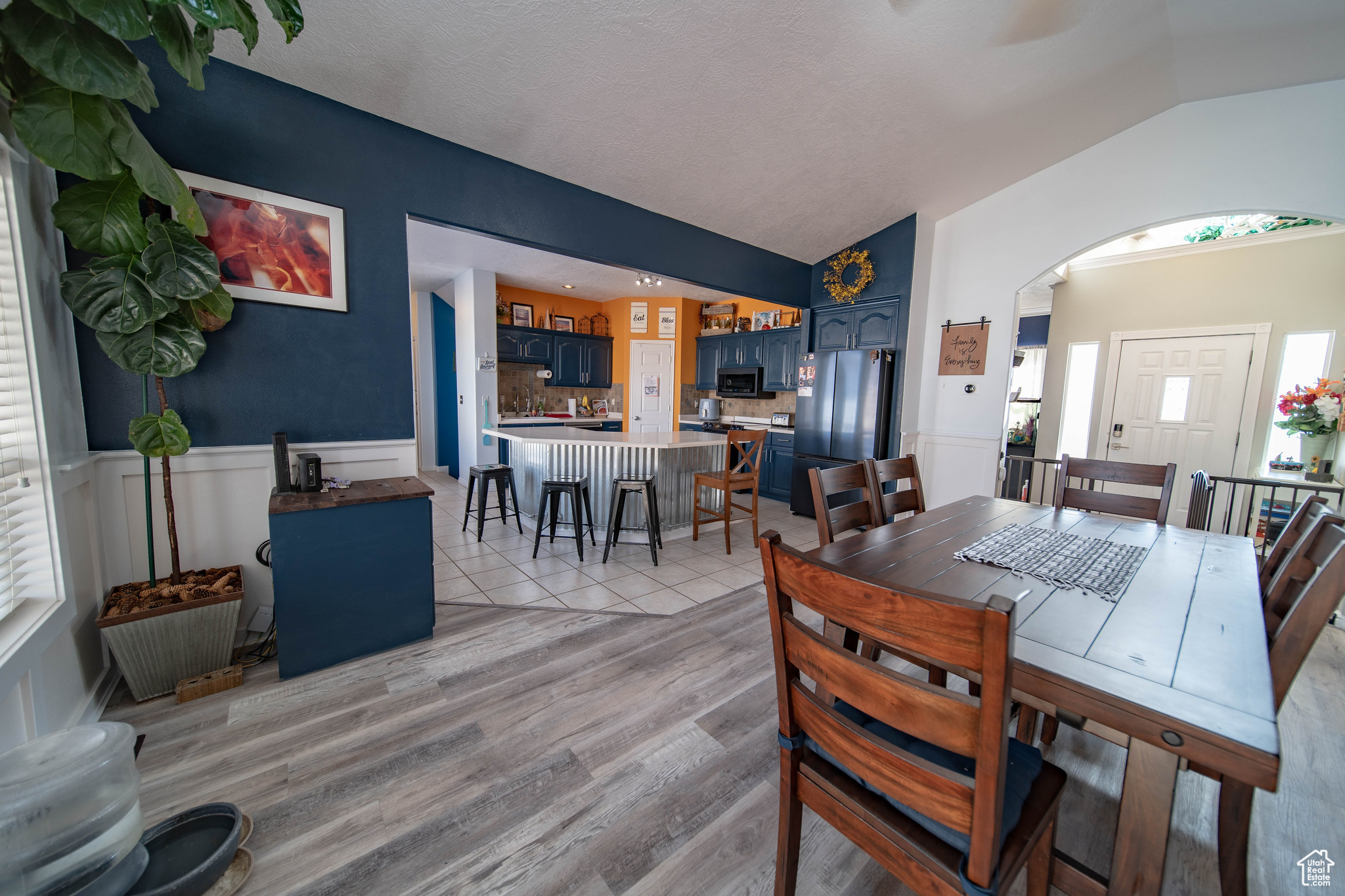 Dining space featuring light hardwood / wood-style floors and vaulted ceiling
