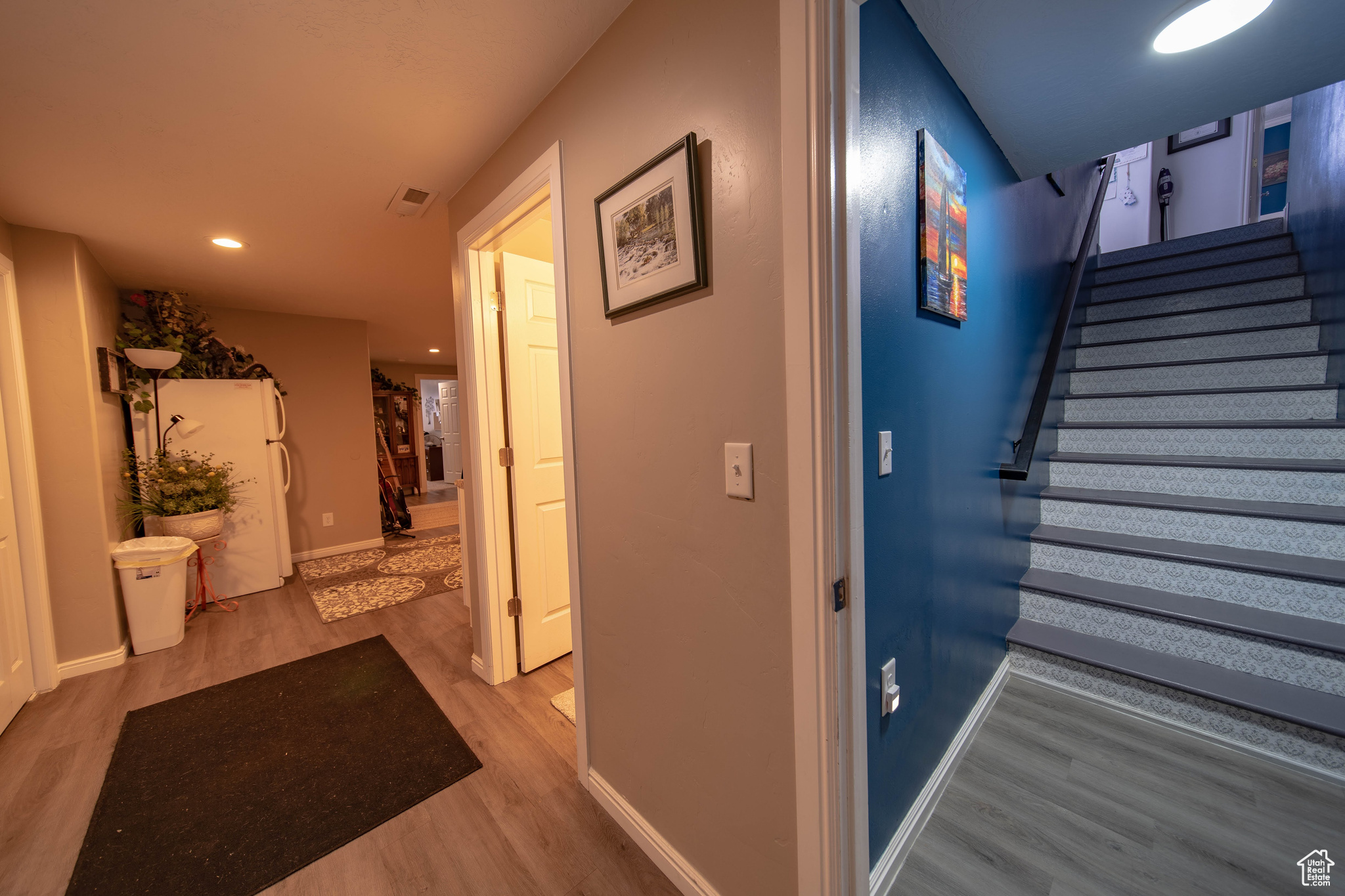 Corridor with hardwood / wood-style flooring