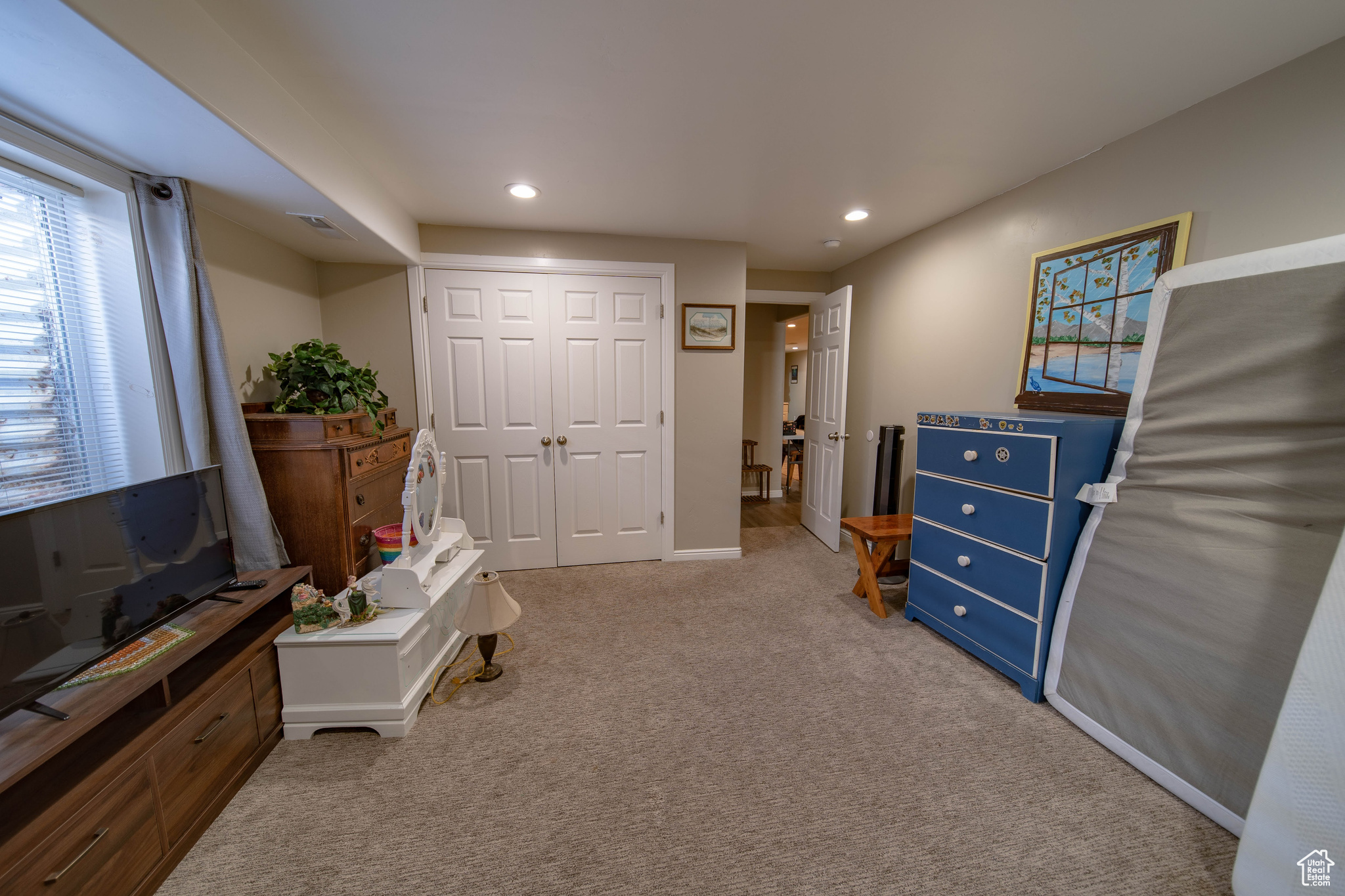 Interior space featuring a closet and light colored carpet