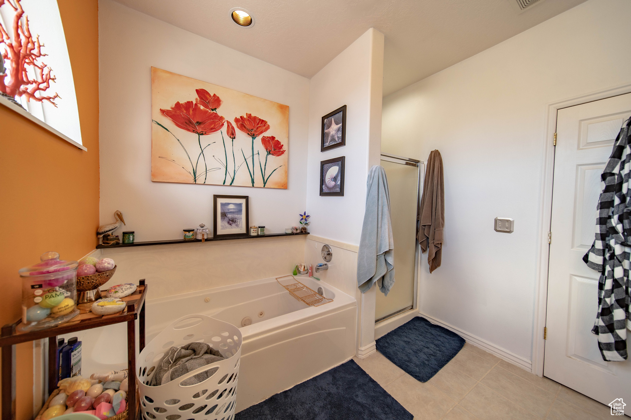 Bathroom featuring tile patterned flooring and independent shower and bath