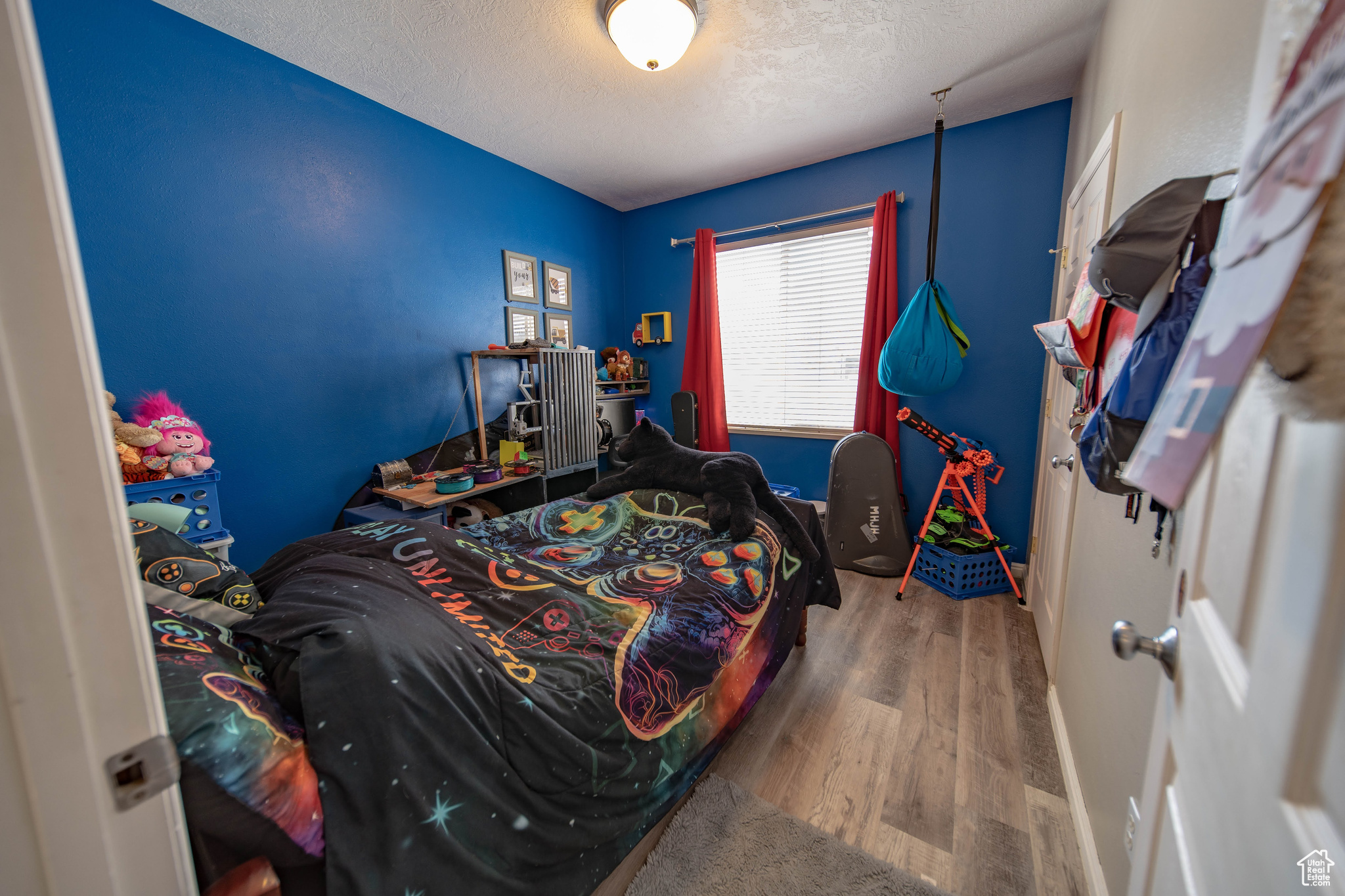 Bedroom with a textured ceiling and hardwood / wood-style flooring