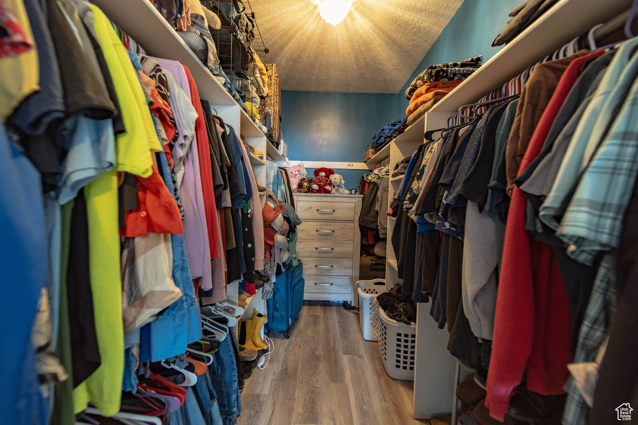 Walk in closet featuring newer vinyl flooring
