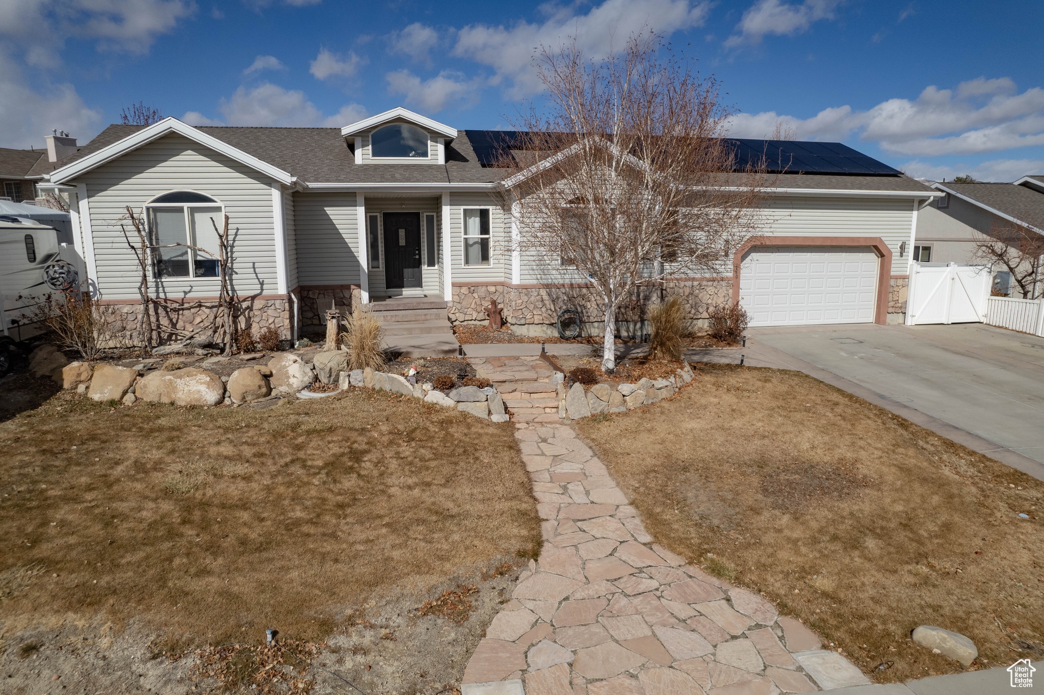 View of front of house featuring solar panels and a garage