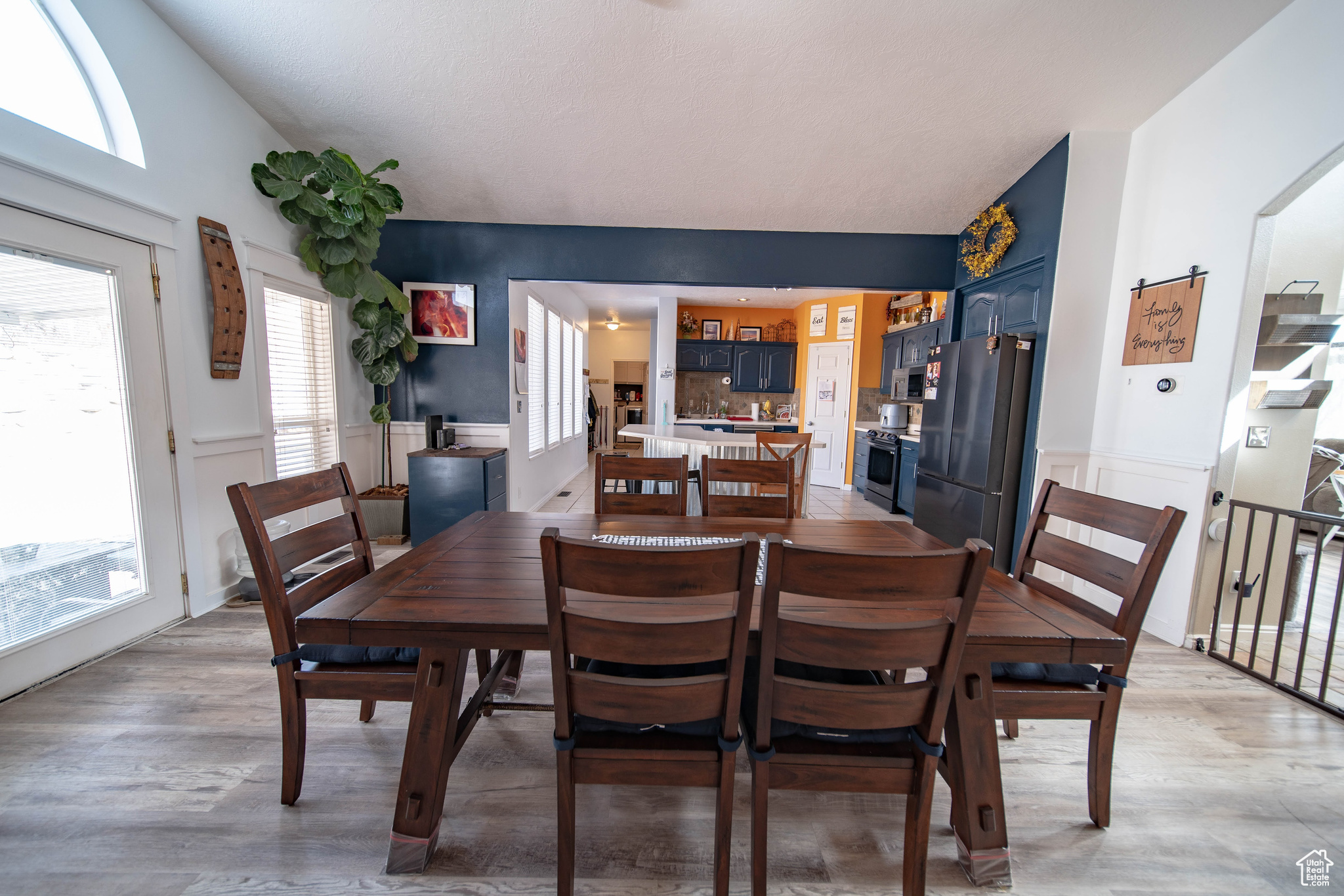 Dining room with light wood-type flooring and lofted ceiling
