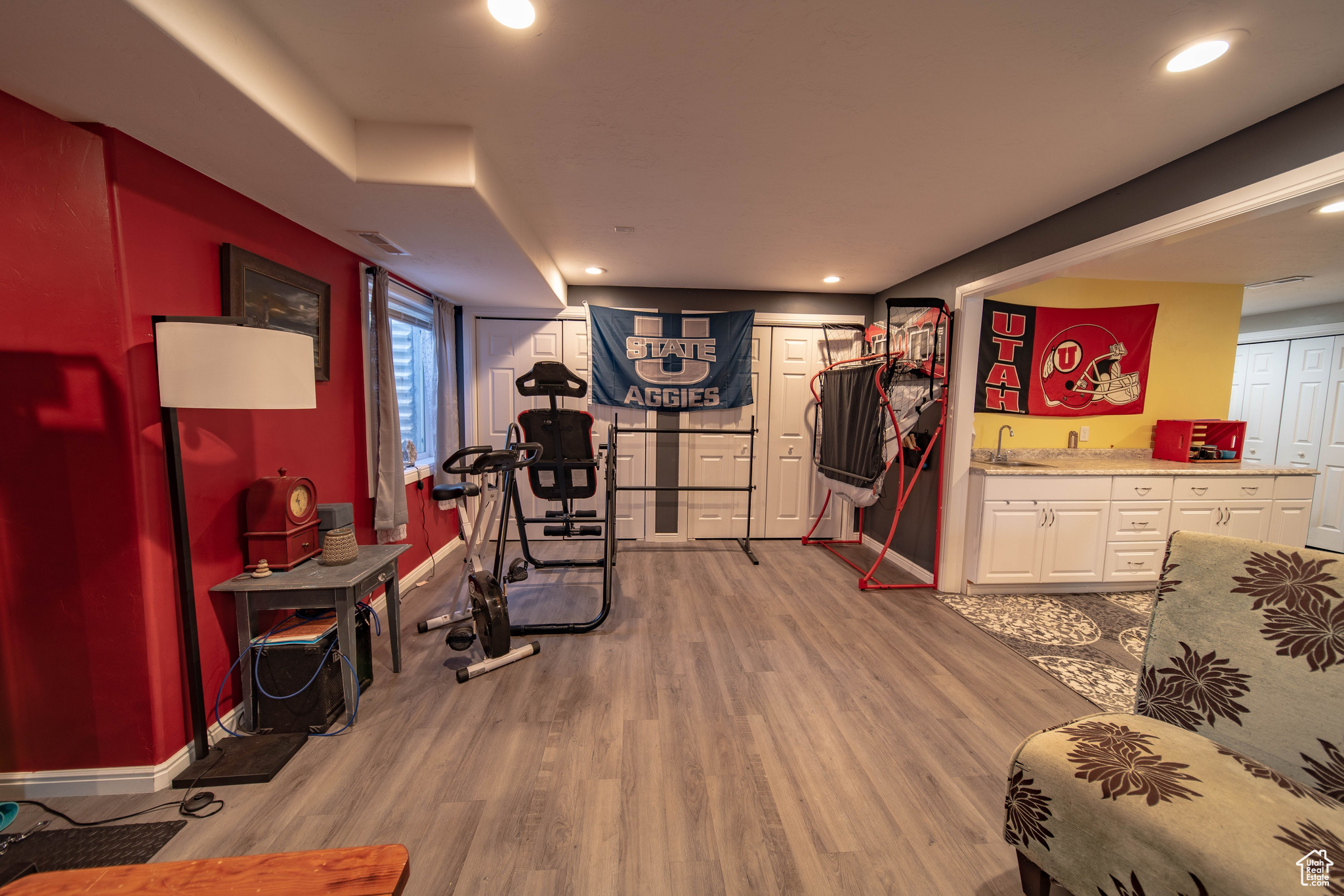 Workout area with wood-type flooring and sink