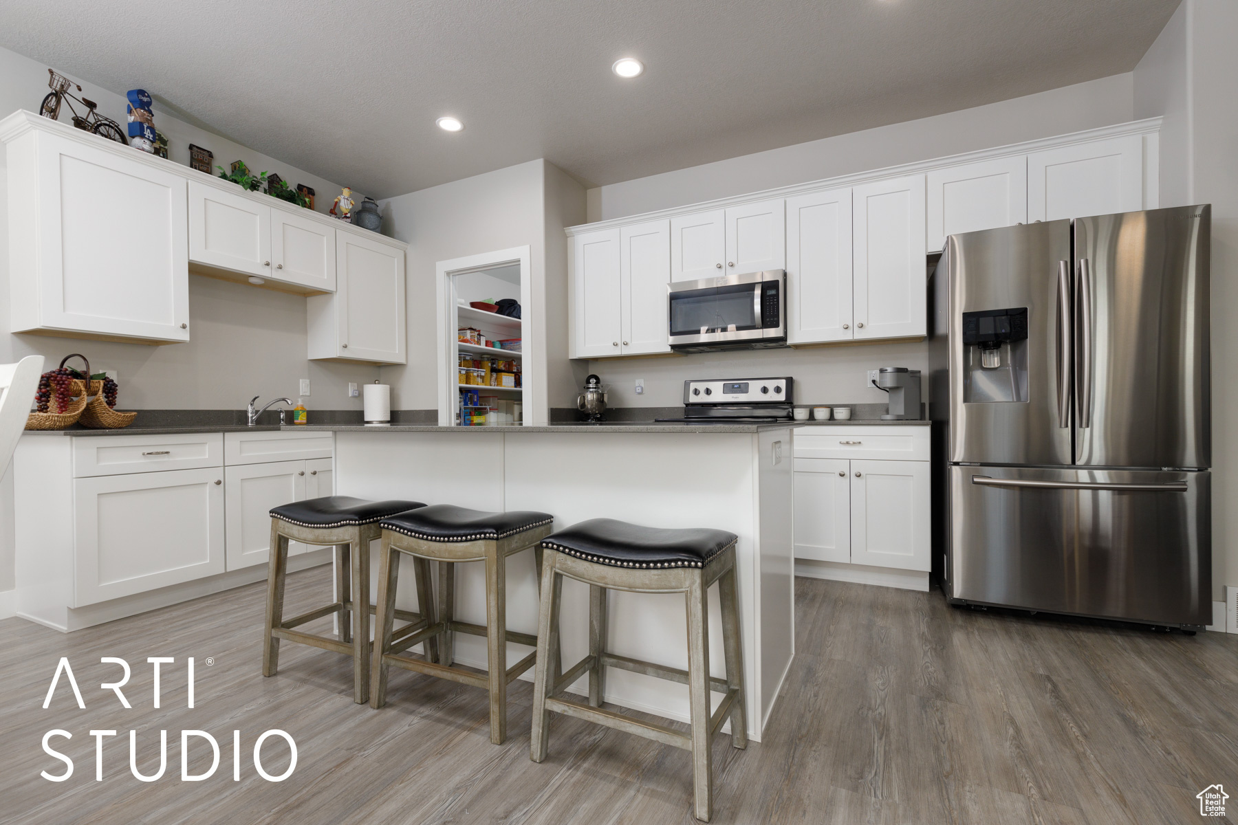 Kitchen with appliances with stainless steel finishes, white cabinets