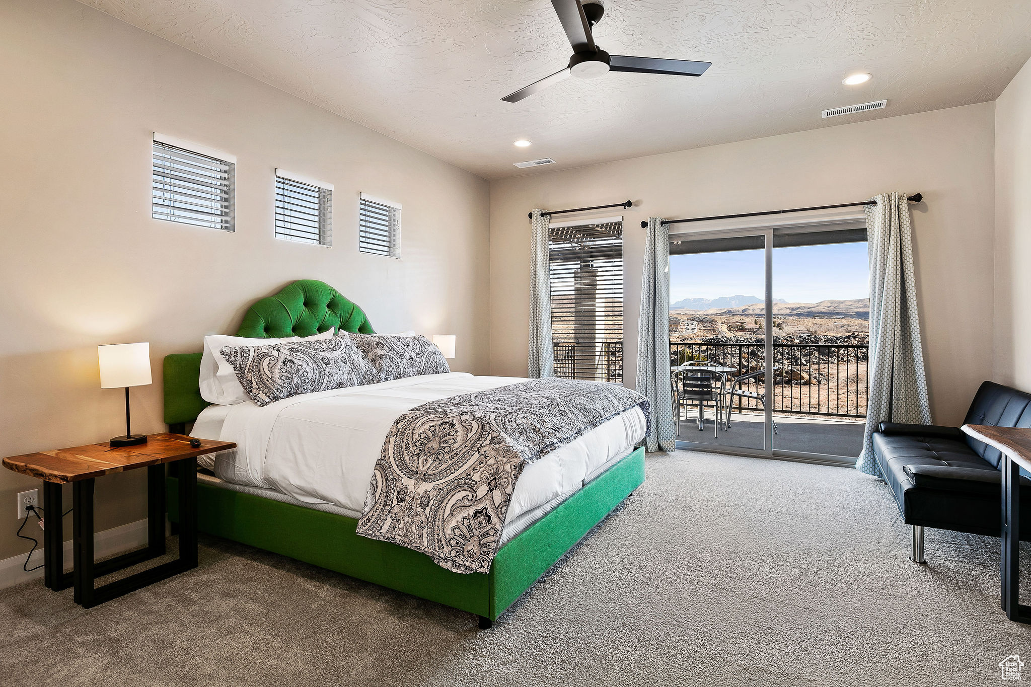 Bedroom featuring a mountain view, carpet flooring, a textured ceiling, ceiling fan, and access to exterior
