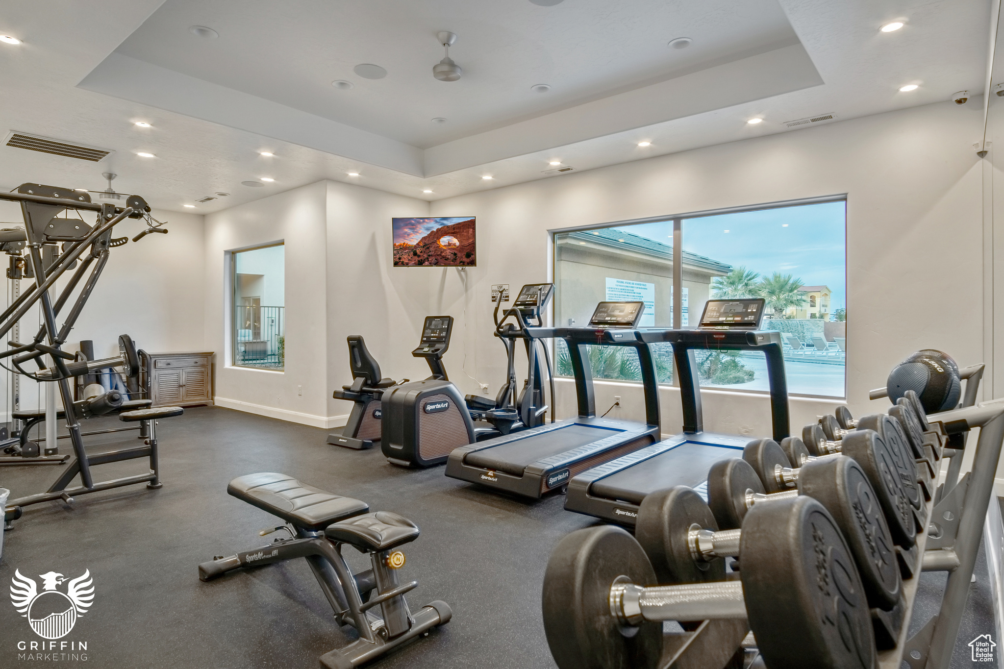 Workout area featuring a tray ceiling