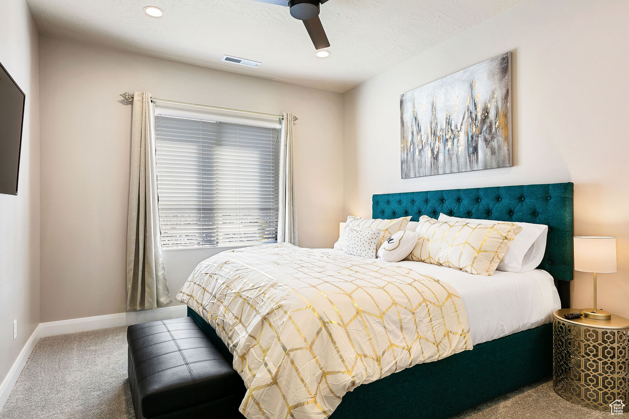 Bedroom featuring ceiling fan and carpet floors
