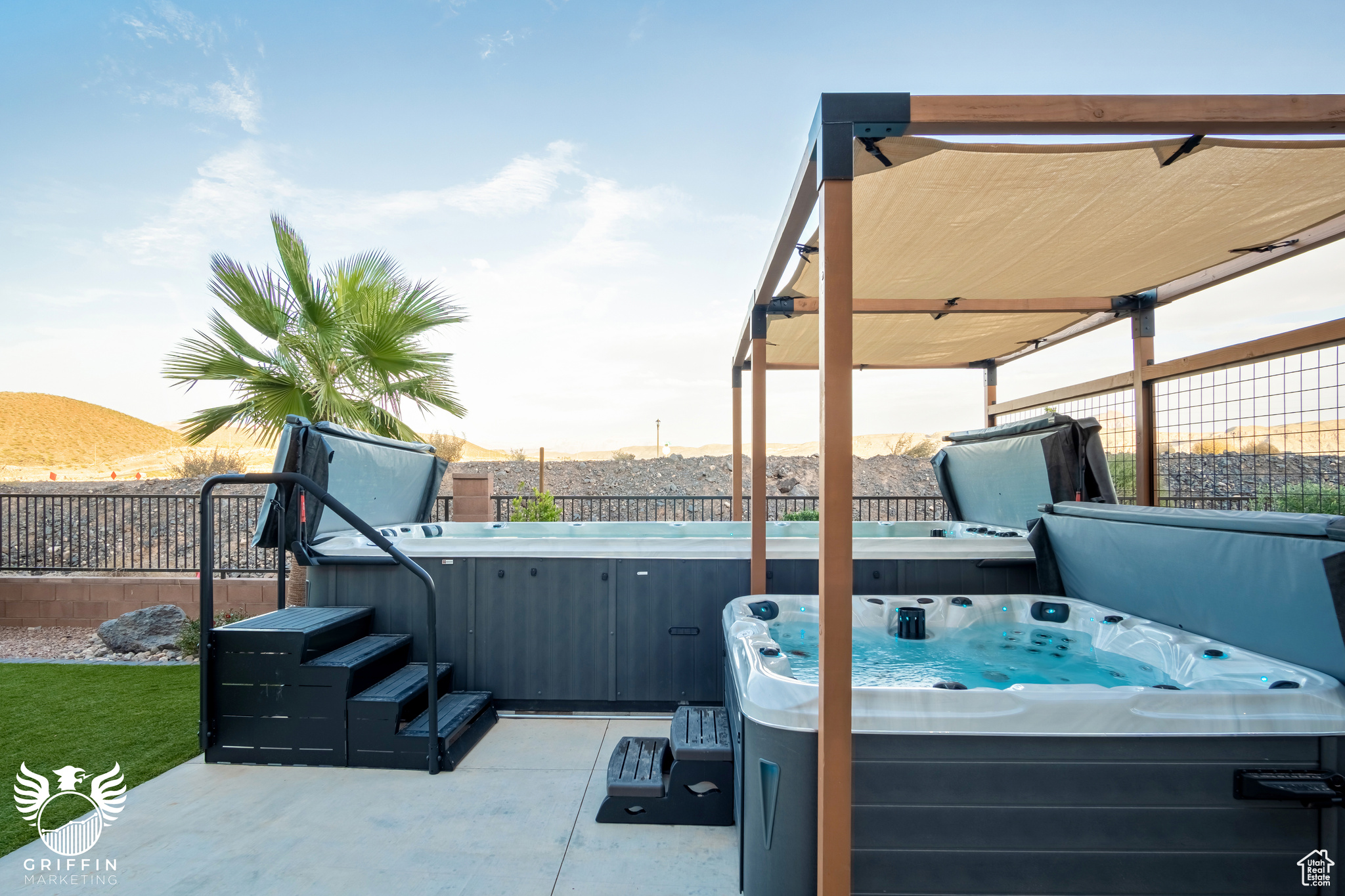 View of patio with a hot tub