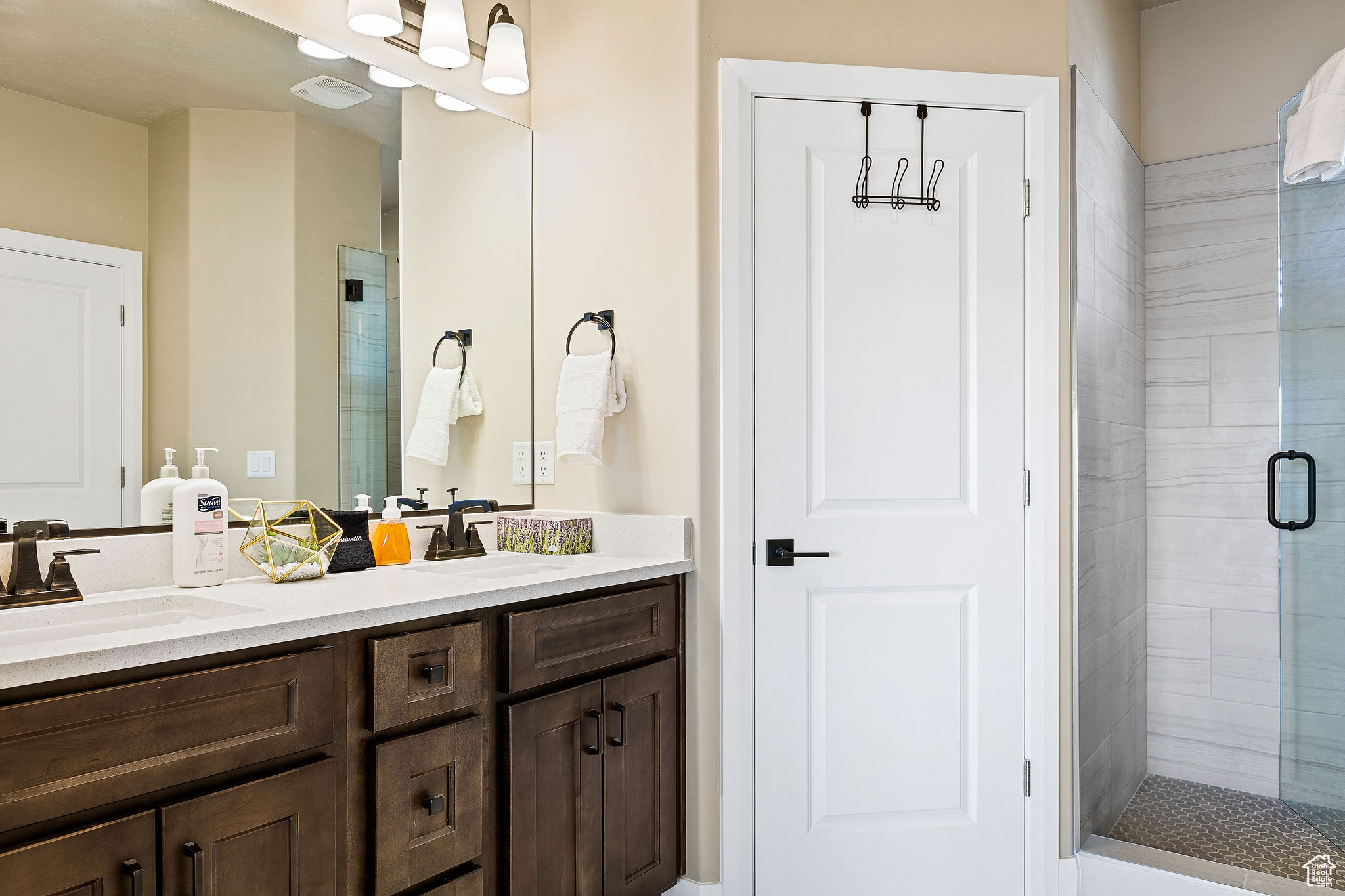Bathroom featuring an enclosed shower and vanity