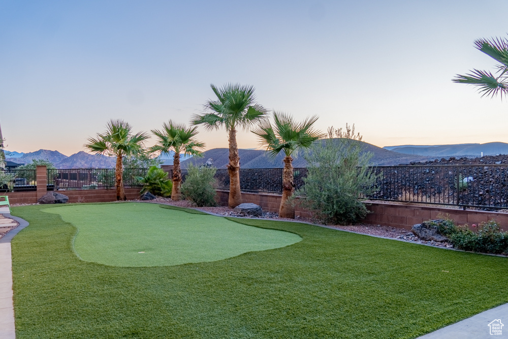 Yard at dusk featuring a mountain view