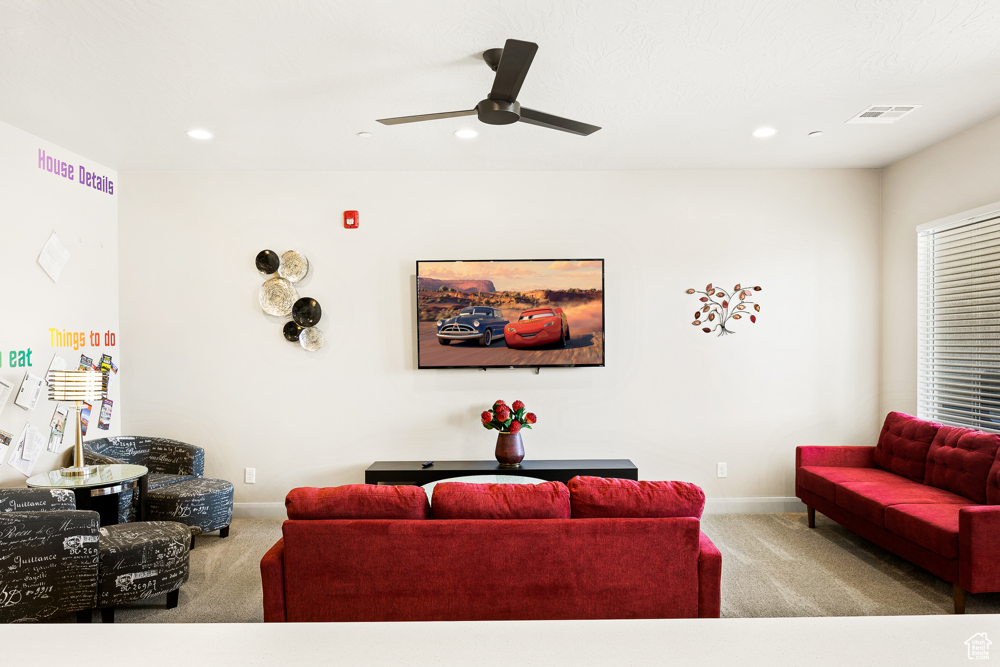 Living room with light carpet and ceiling fan