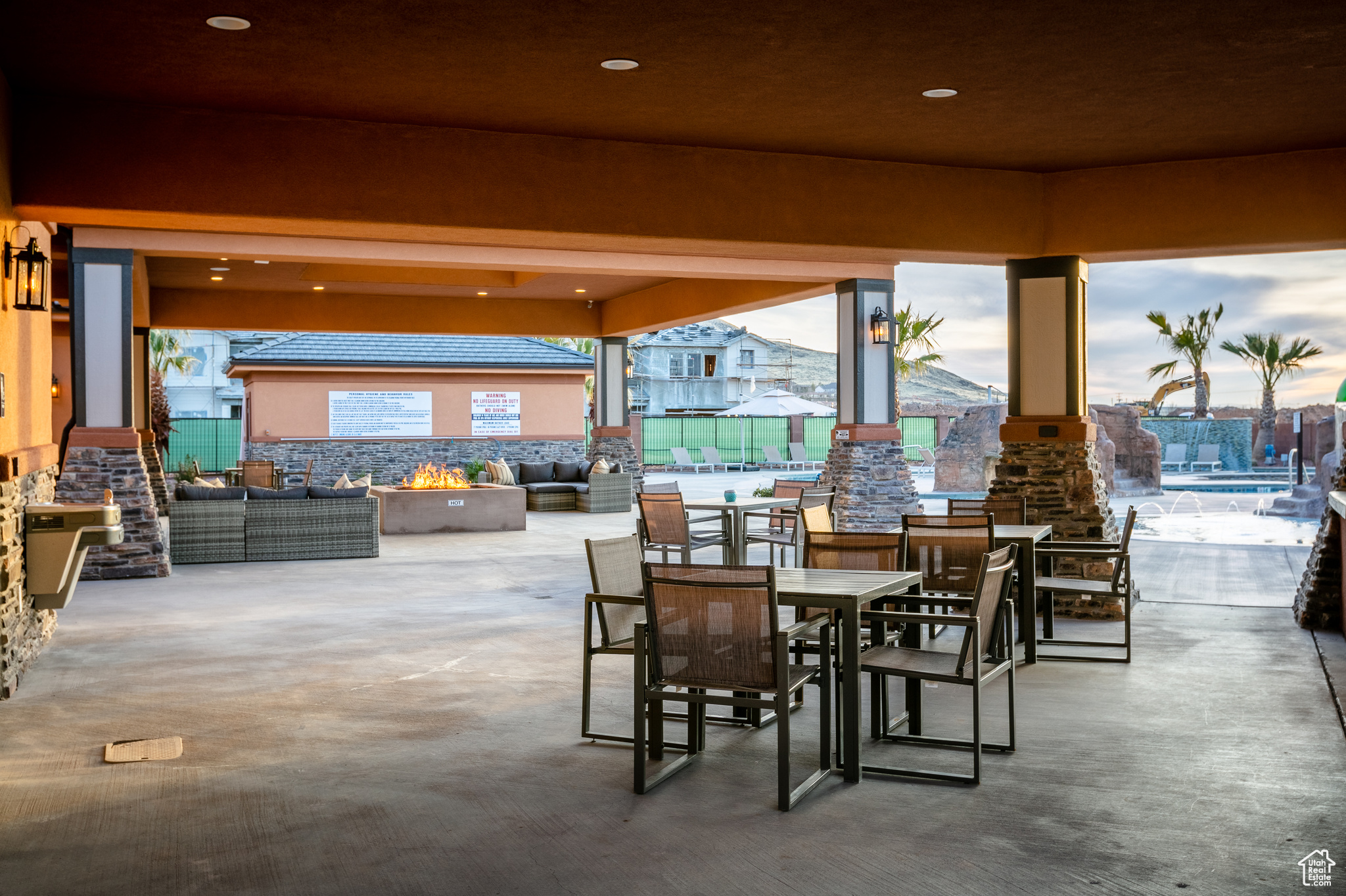 View of patio with a gazebo and an outdoor living space with a fire pit