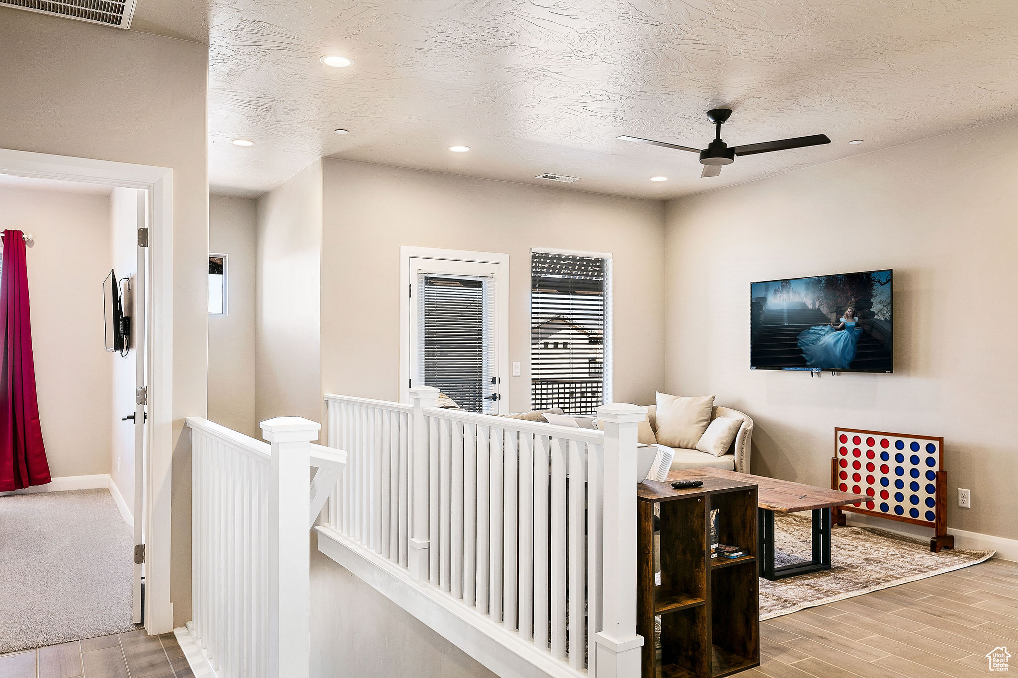 Living room with ceiling fan and a textured ceiling