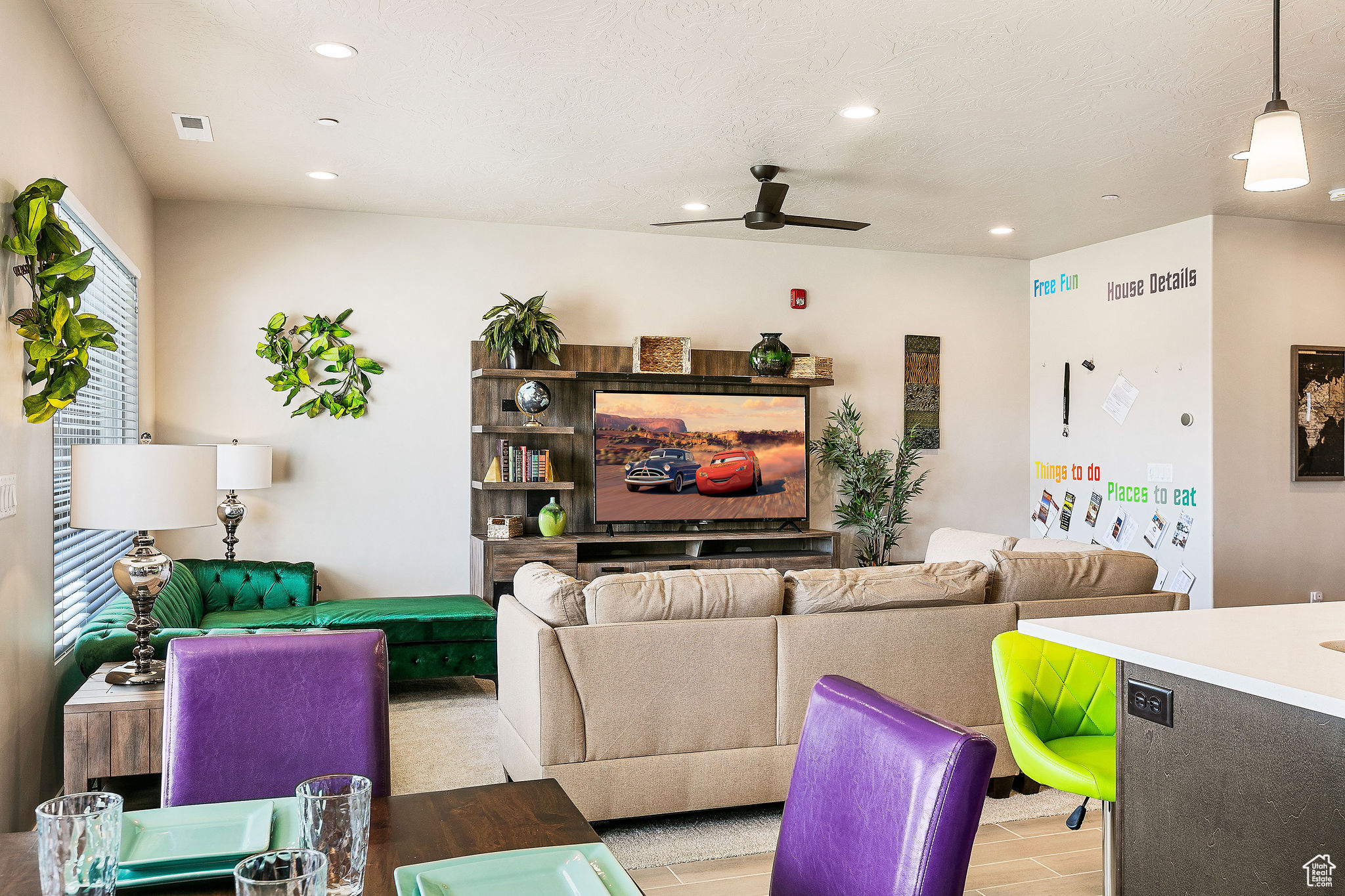 Living room with light hardwood / wood-style flooring, ceiling fan, and a textured ceiling