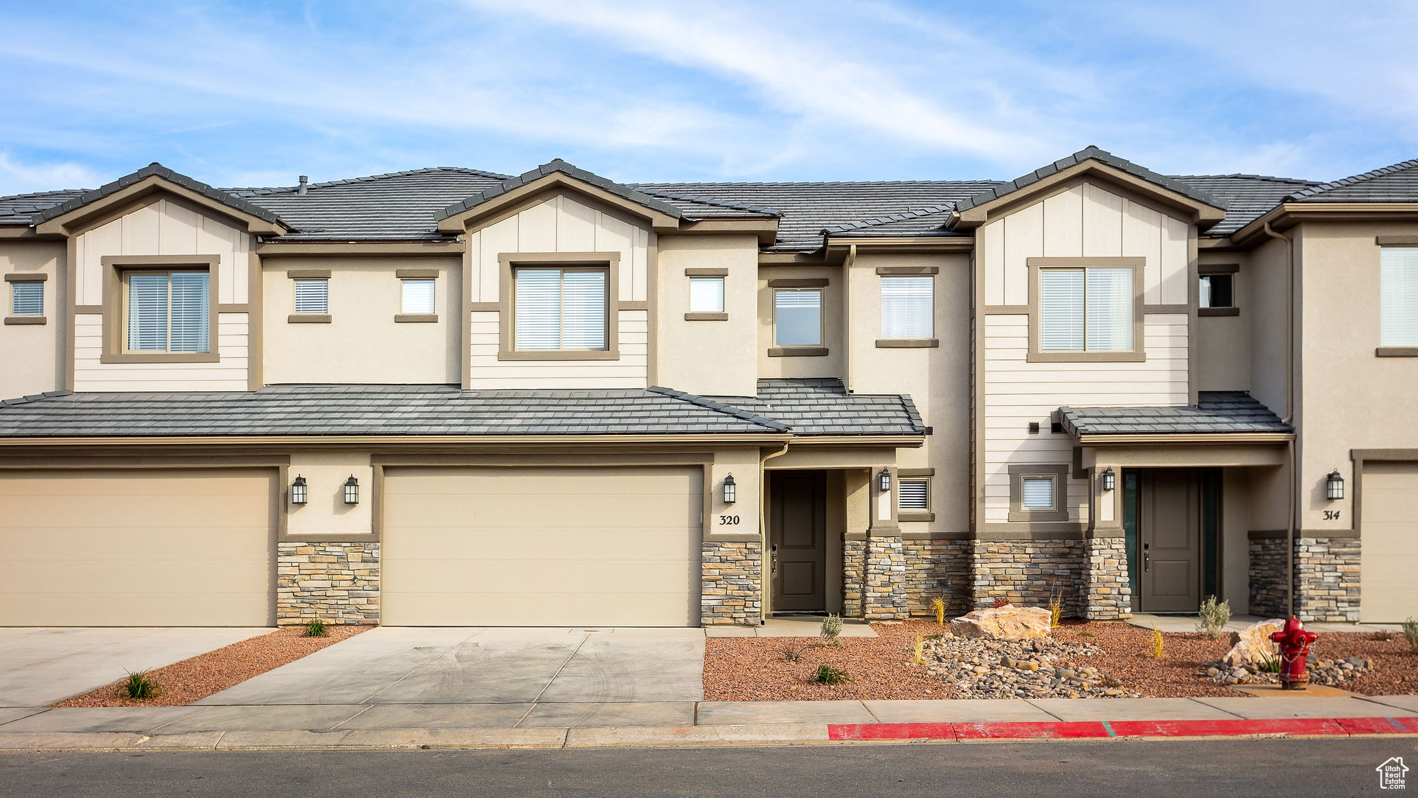 Townhome / multi-family property featuring a garage
