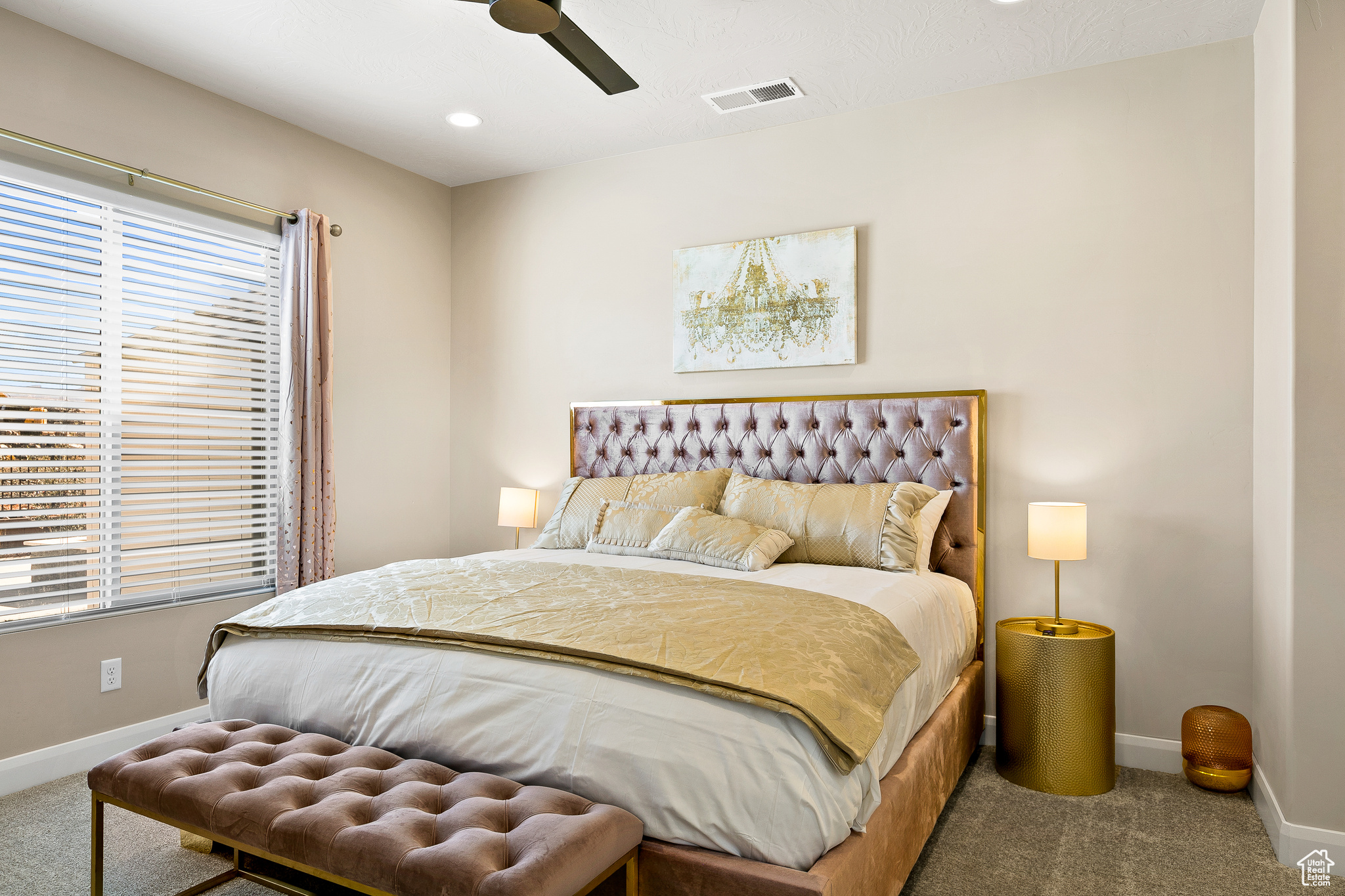Carpeted bedroom featuring ceiling fan