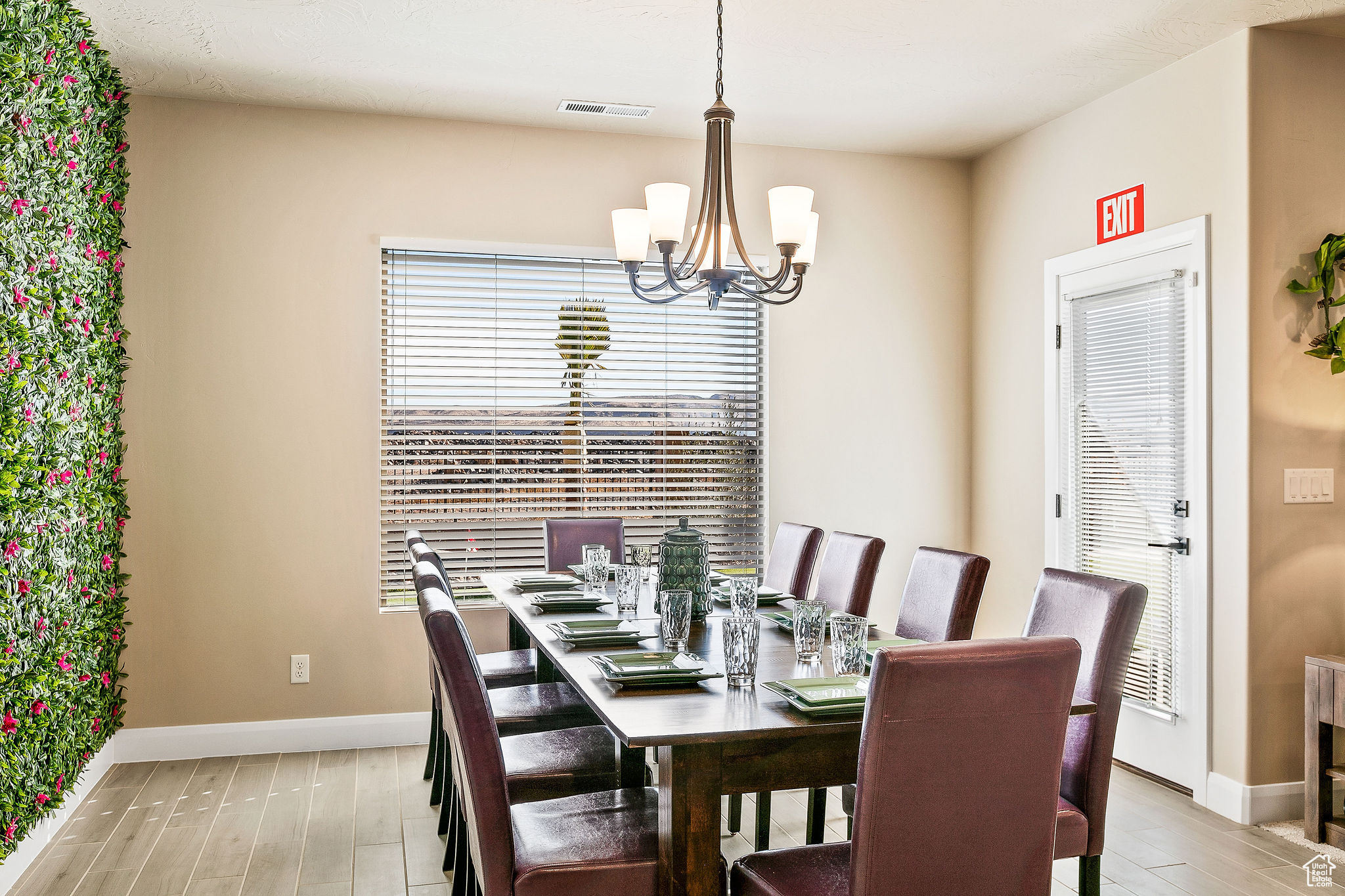 Dining room with light wood-type flooring and a chandelier